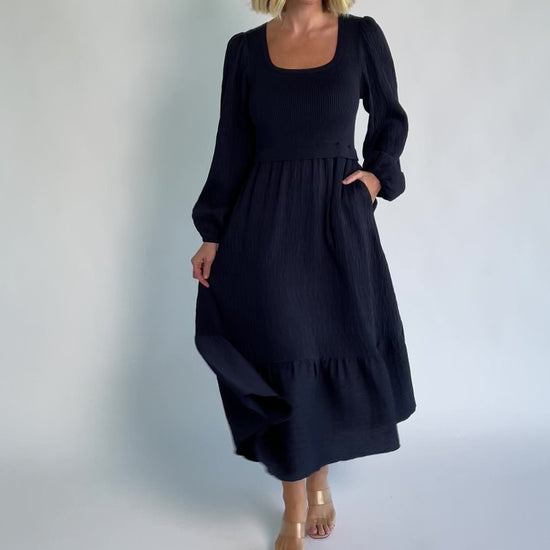 Alva Sweater Dress in Dusty Navy with ribbed knit bodice, square neckline, ruffle shoulders, long sleeves, and midi skirt.