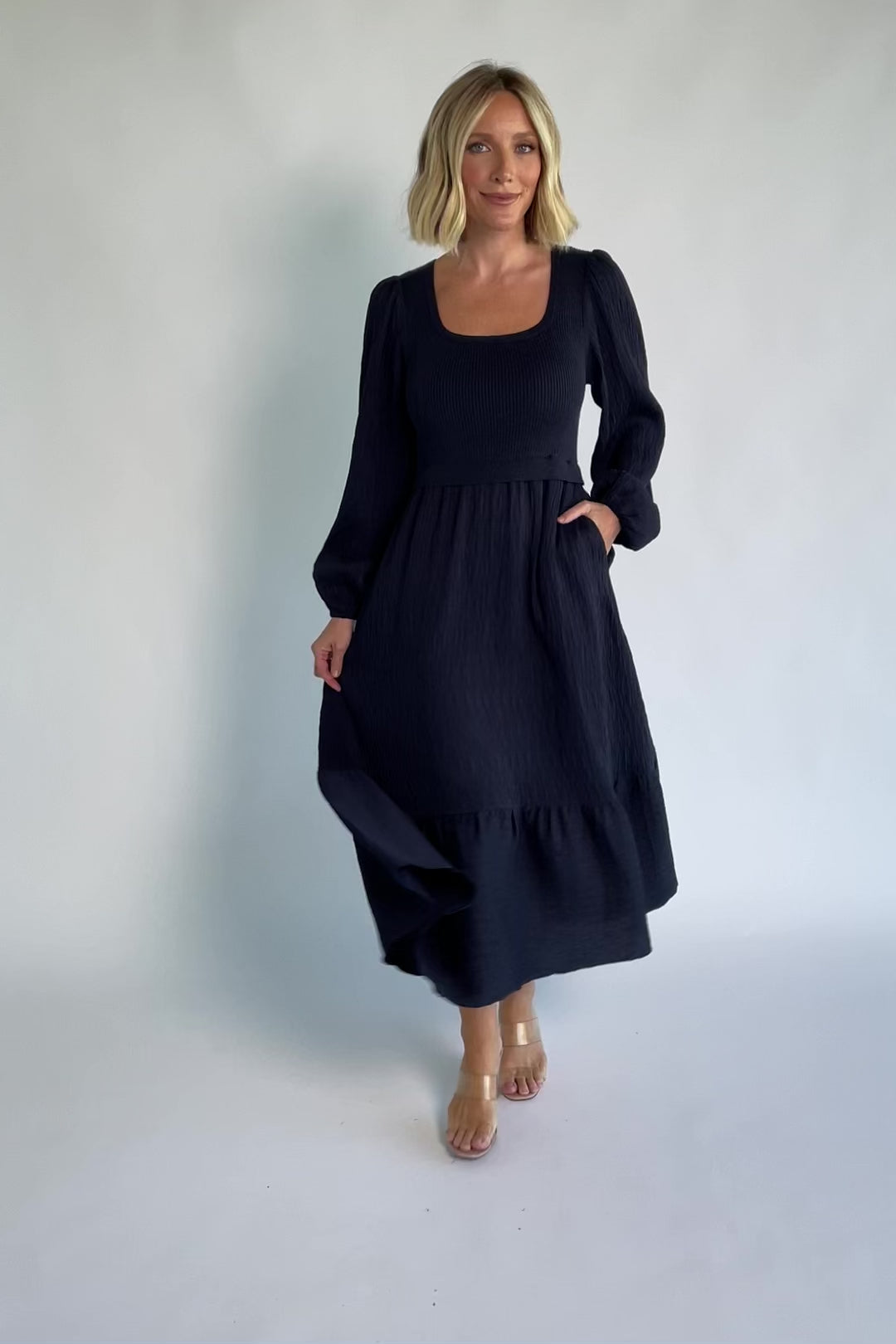 Alva Sweater Dress in Dusty Navy with ribbed knit bodice, square neckline, ruffle shoulders, long sleeves, and midi skirt.