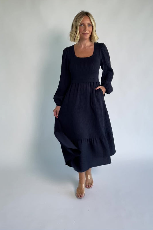 Alva Sweater Dress in Dusty Navy with ribbed knit bodice, square neckline, ruffle shoulders, long sleeves, and midi skirt.