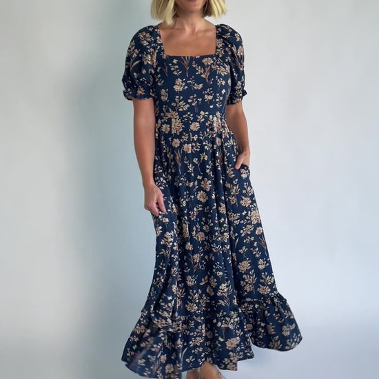 Addison Maxi Dress in Dark Blue Floral with square neckline, oversized sleeves, smocked back, and tiered ruffle skirt.