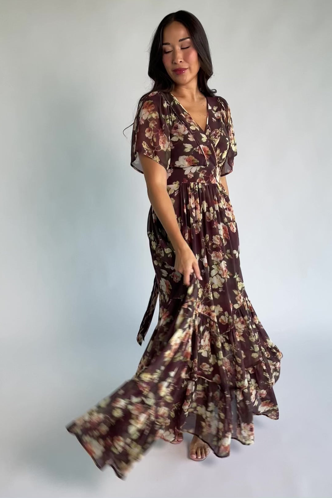 Katherine Maxi Dress in Vintage Clove Floral with V-neckline, flutter sleeves, adjustable waist ties, and tiered skirt.