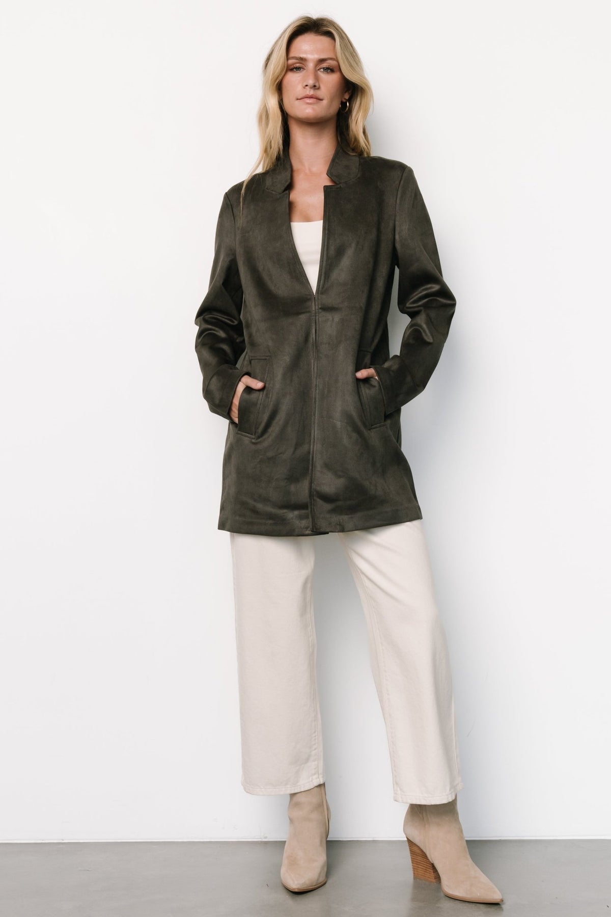 Front view of charcoal faux-suede thigh-length jacket with notch collar, deep V bodice, long sleeves, and front pockets.