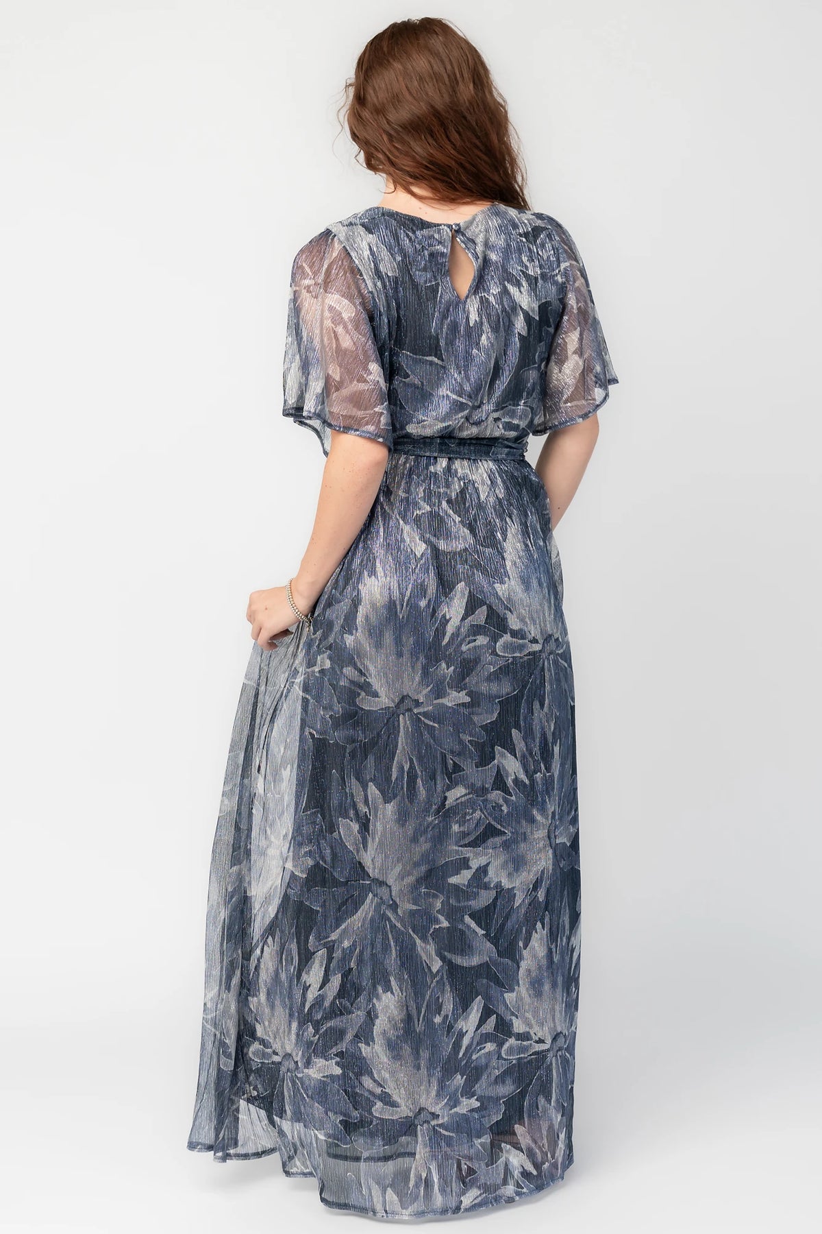Rachel Maxi Dress in Blue Multi with silver shimmer leaves, surplice neckline, sash waist, and leg slit.