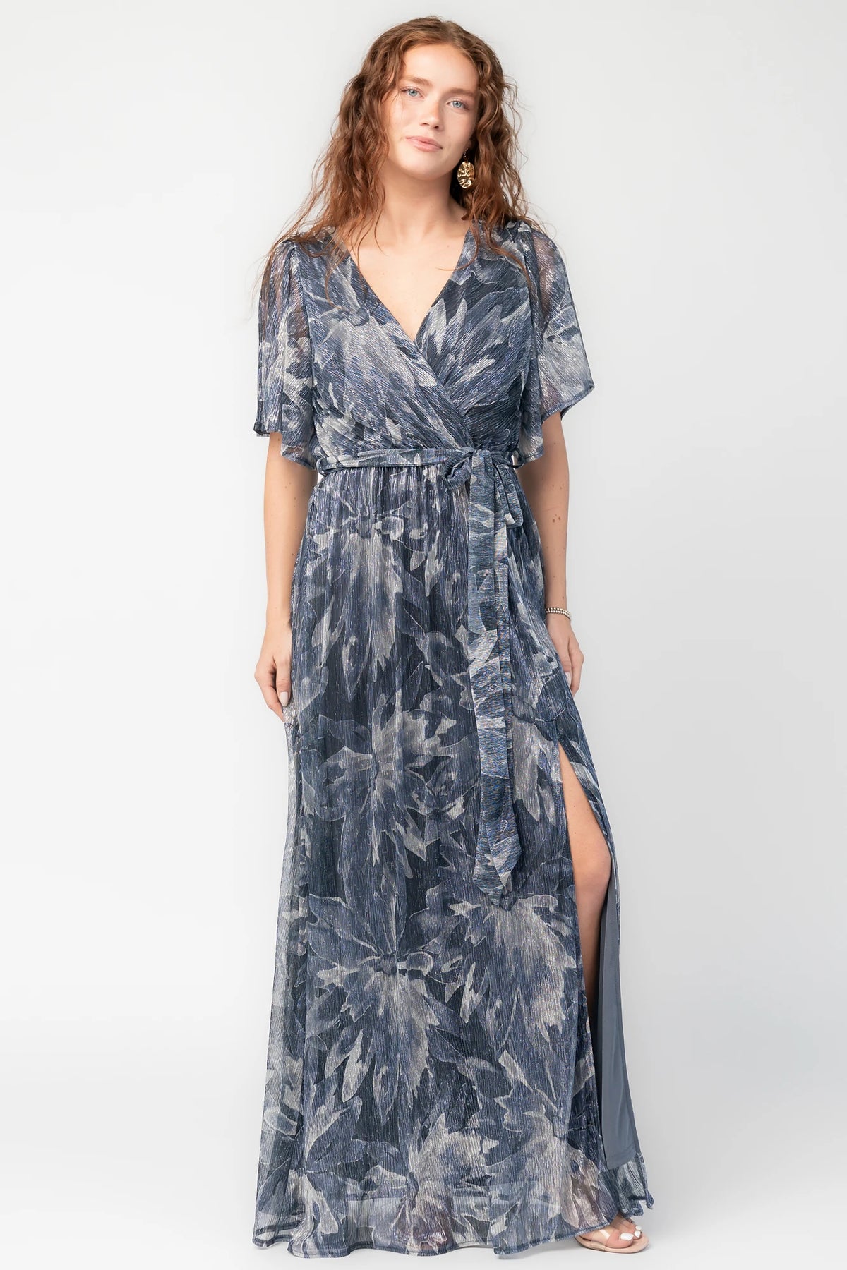 Rachel Maxi Dress in Blue Multi with silver shimmer leaves, surplice neckline, sash waist, and leg slit.