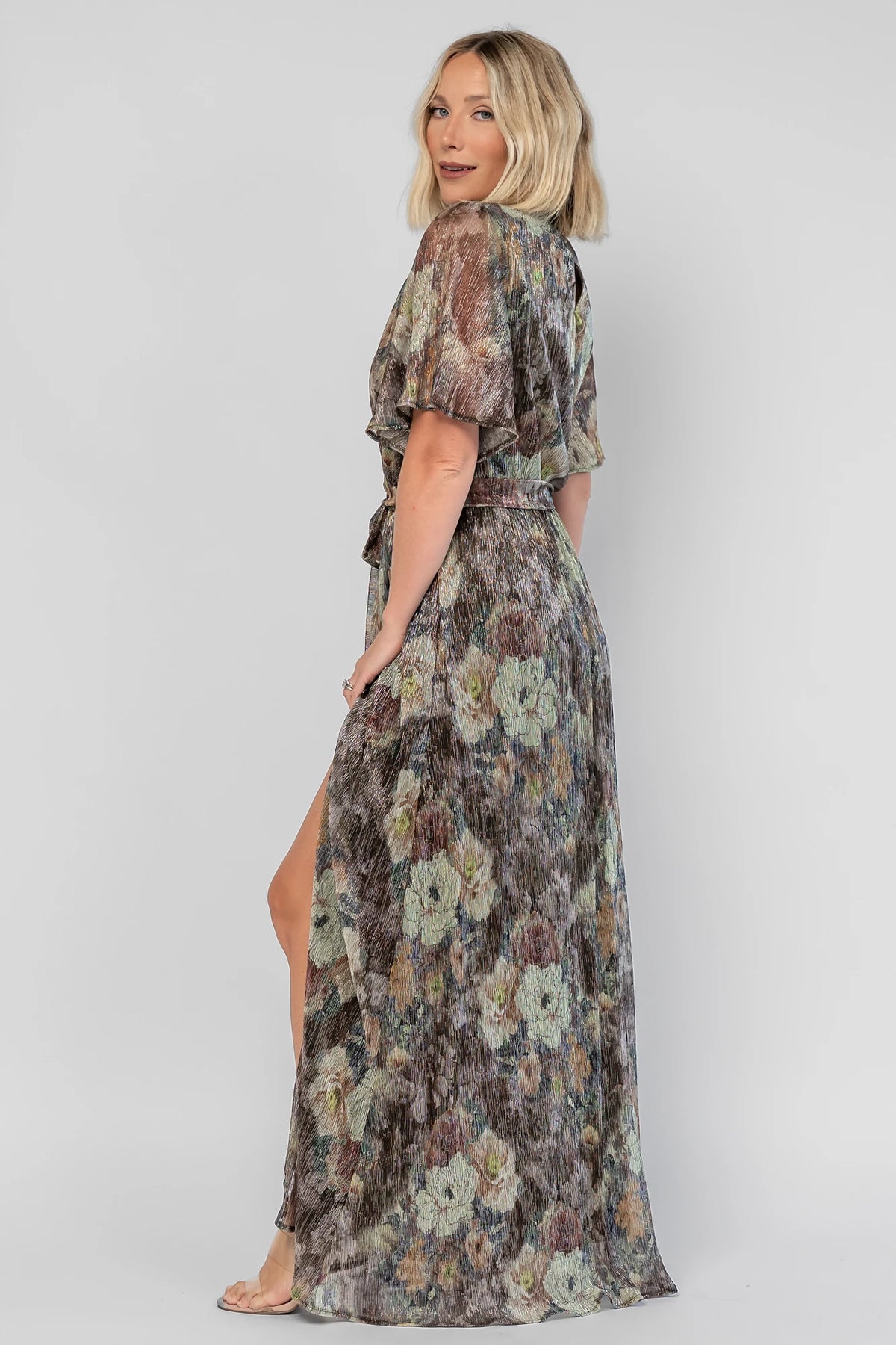 Rachel Maxi Dress in Green Multi with abstract floral details, a faux-wrap neckline, and semi-sheer overlay.