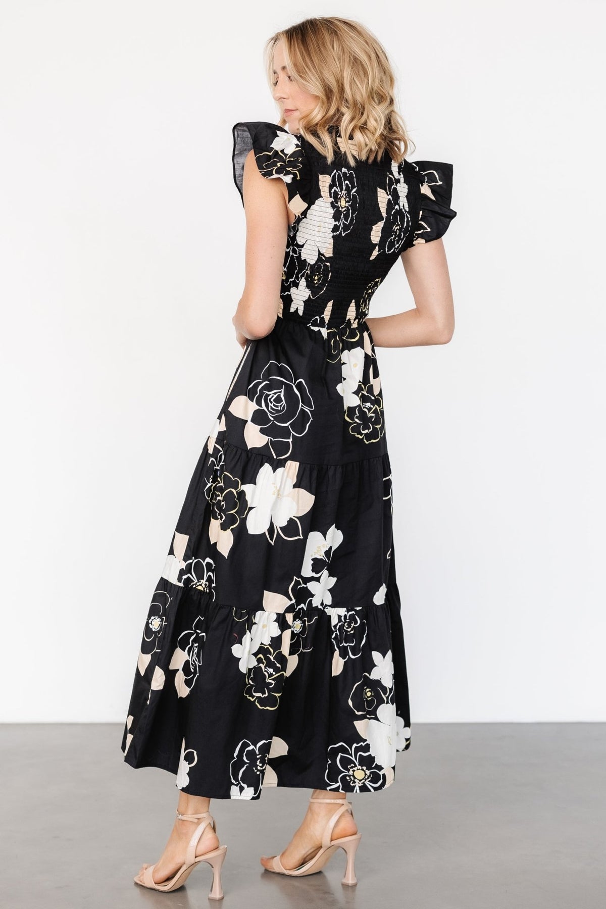 Detail view of short ruffle sleeve and floral print on the Ranchero smocked maxi dress, showing fabric and seam finish.