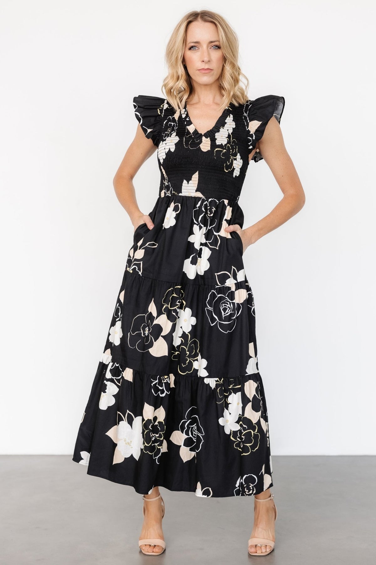 Back and full-length view of the Ranchero maxi dress in black floral print showing the multi-tiered skirt and overall silhouette.