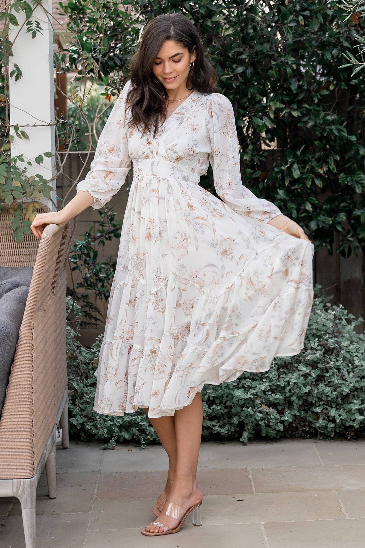 Detail view of the angled tiered midi skirt and tiered hem of the Raven dress, illustrating soft volume and graceful movement.