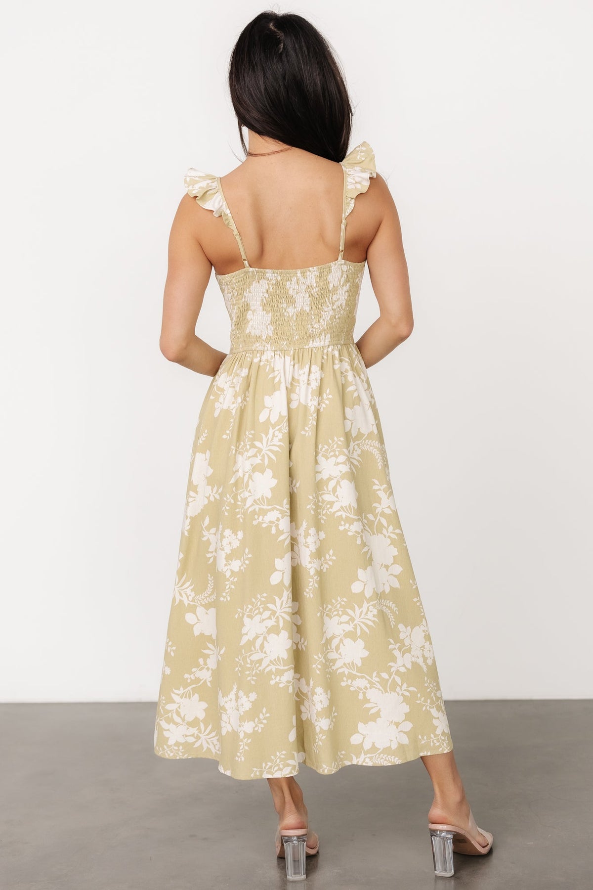 Side view of Renna Button Top Dress highlighting hidden side pocket, adjustable ruffled sleeve, and the skirt's smooth lining.