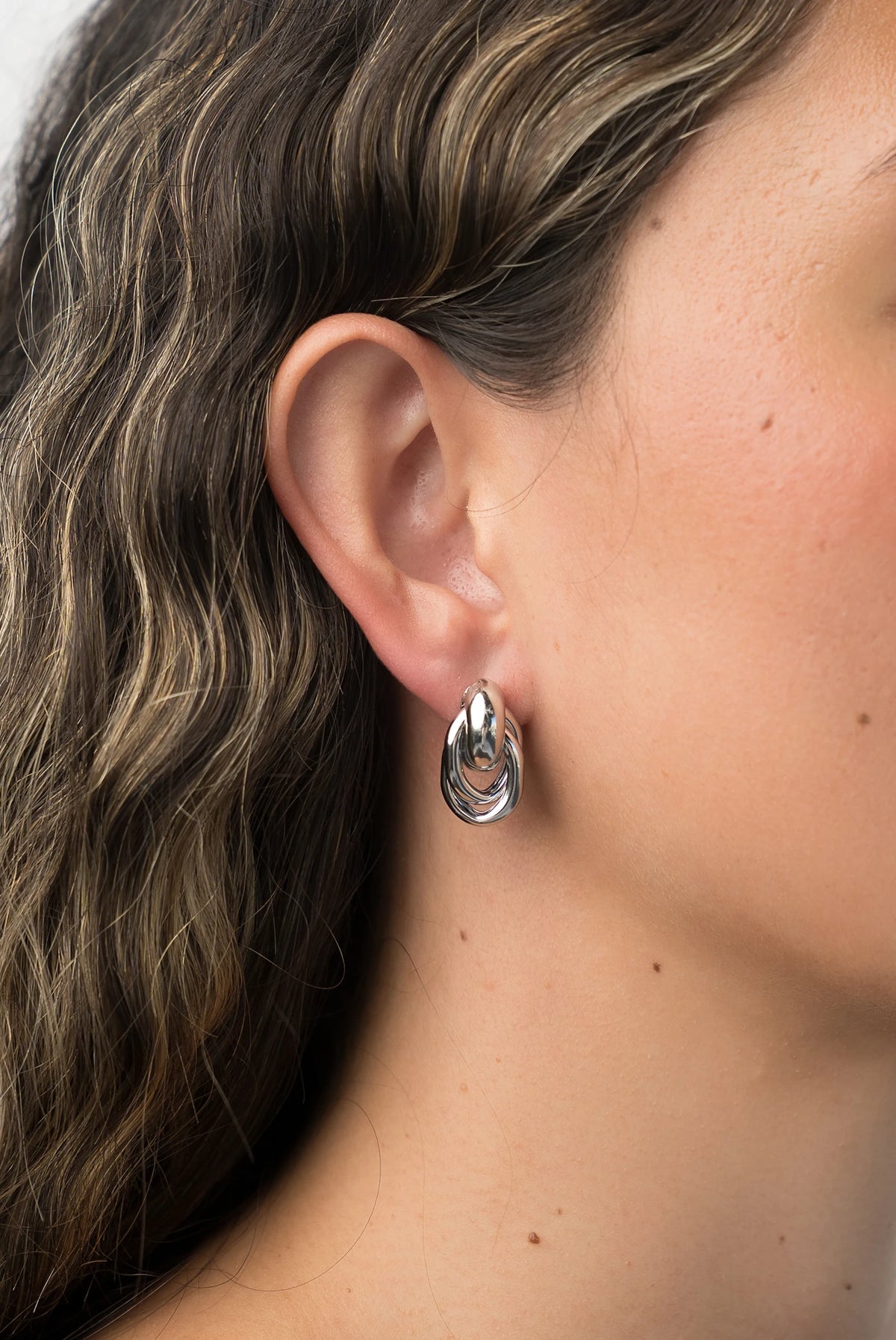Revita Statement Earrings in Silver with bold interlocking design and polished finish.