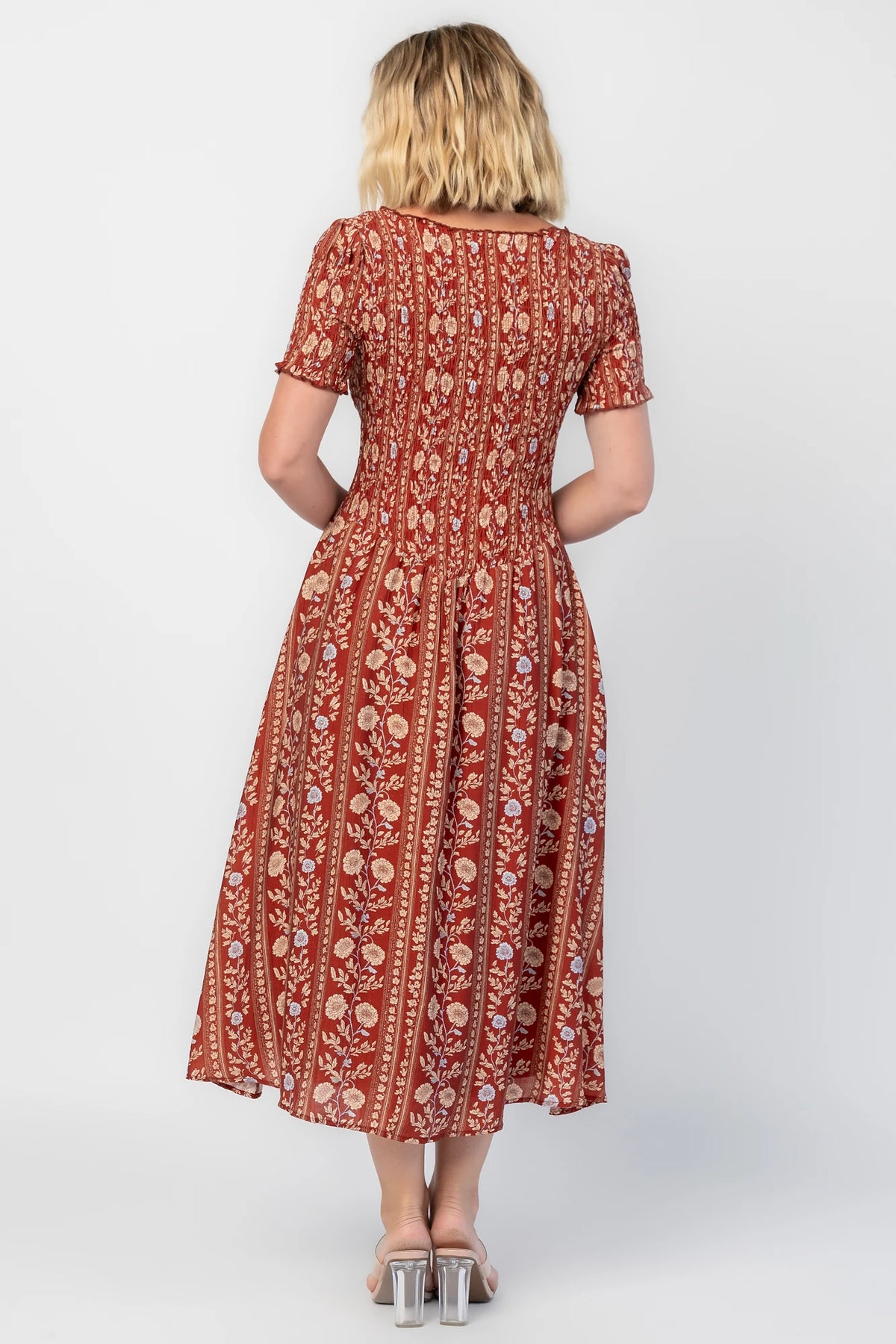 Rhonda Smocked Midi Dress in Rust Print with a round neckline, smocked bodice, and ruffled sleeve edges.