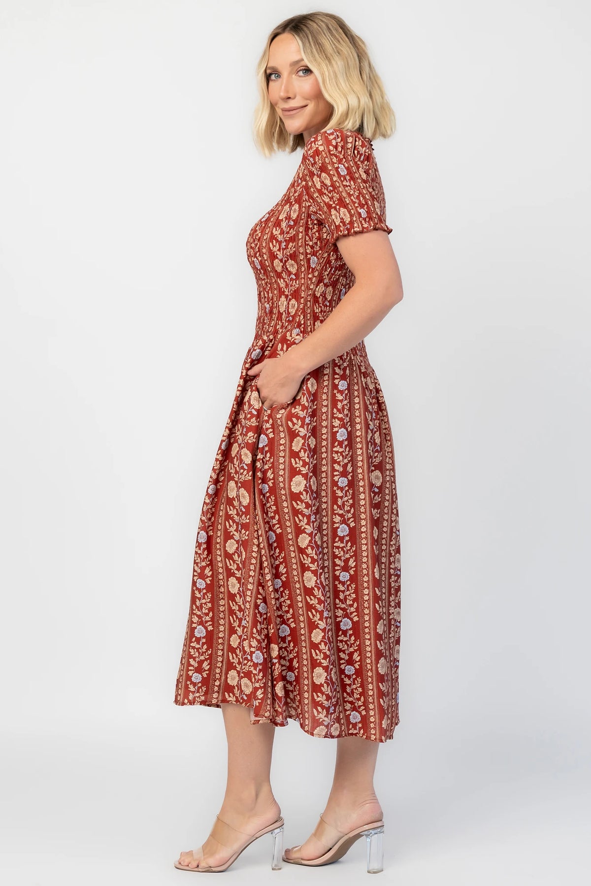 Rhonda Smocked Midi Dress in Rust Print with a round neckline, smocked bodice, and ruffled sleeve edges.