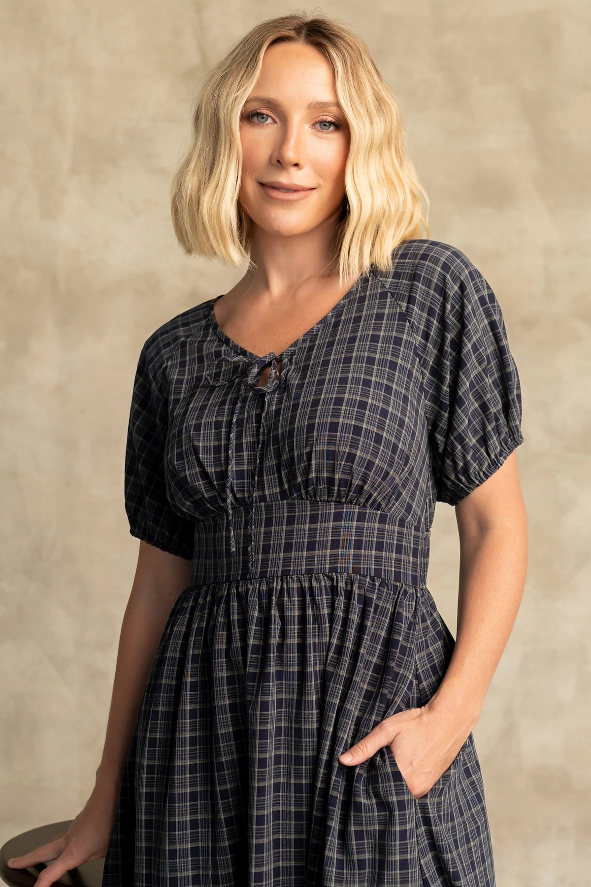 Rosalyn Midi Dress in Navy Plaid with V-neckline, adjustable bust tie, underbust panel, and midi skirt.