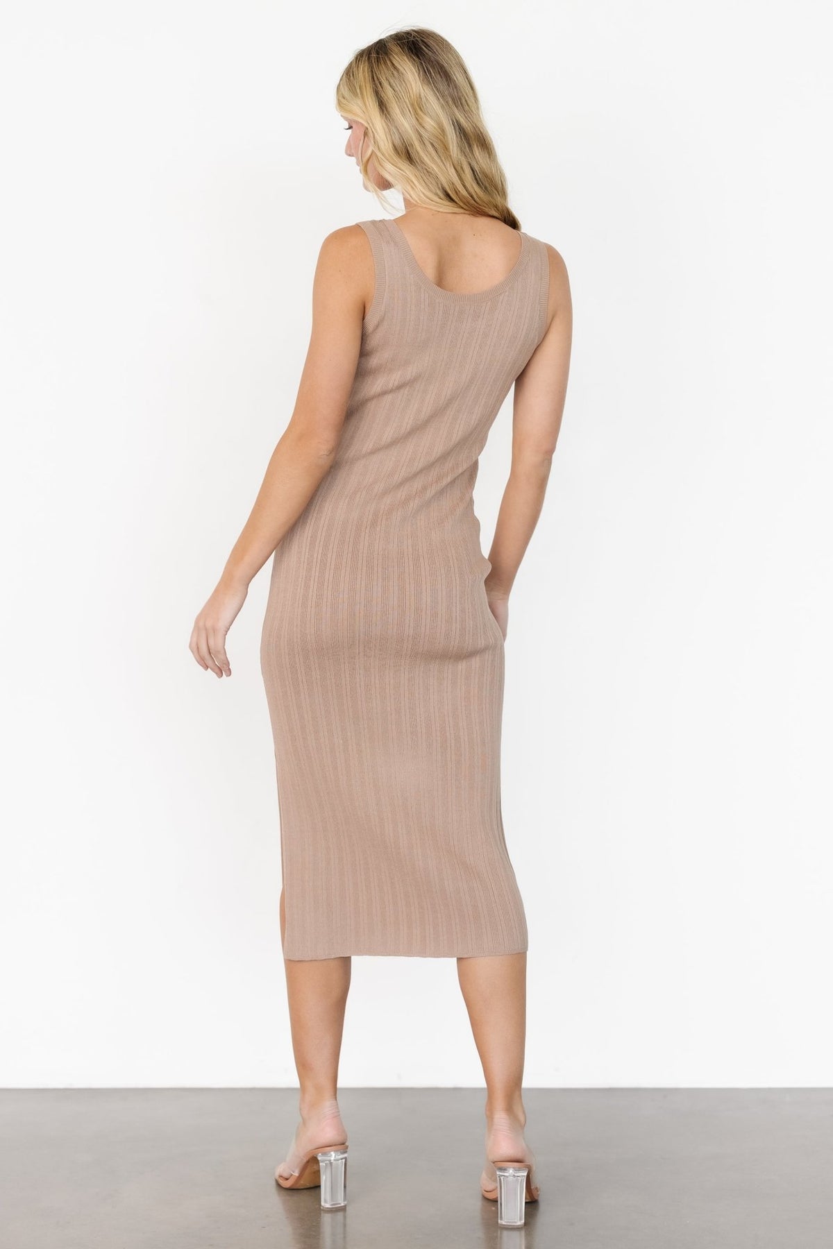 Side view of natural tank midi dress emphasizing the right-side knee-high slit and streamlined silhouette.