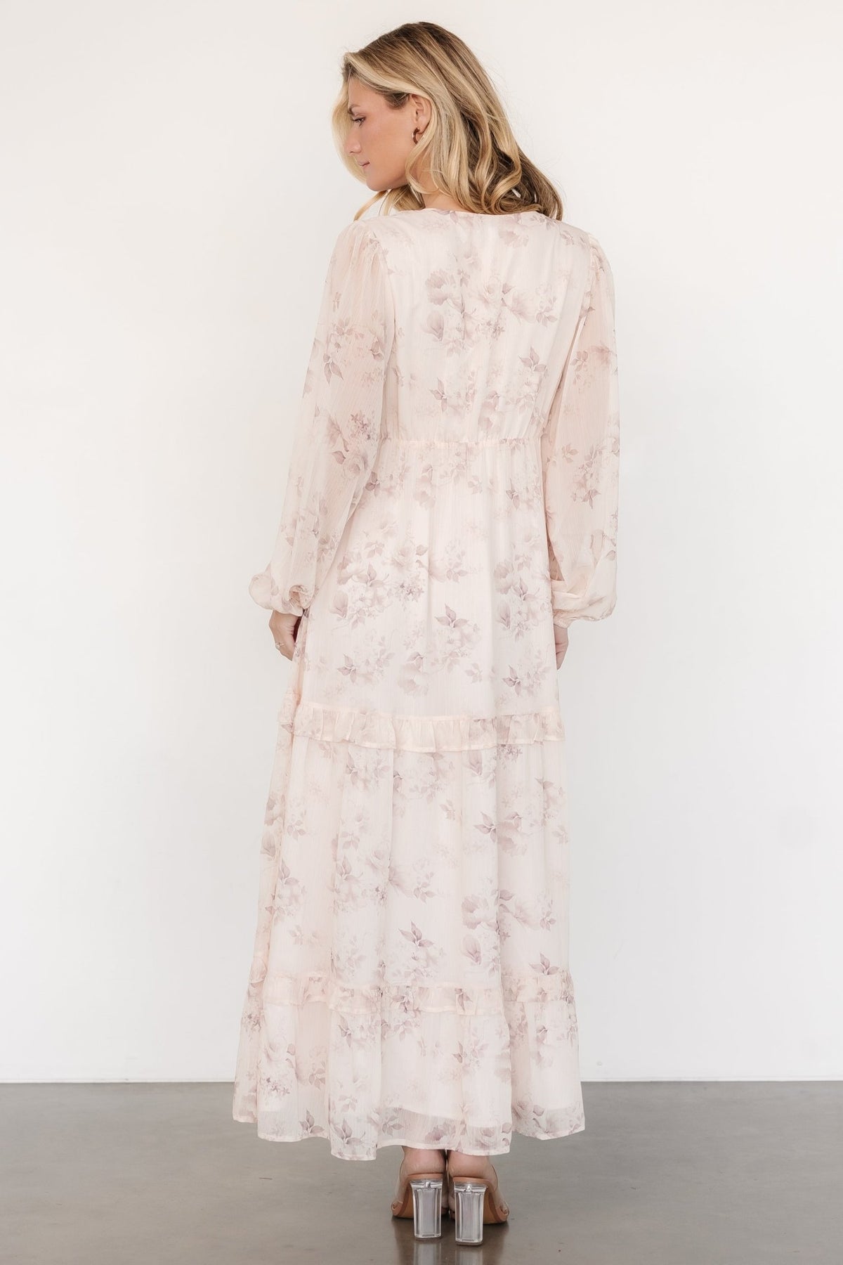 Back and side view of the maxi dress on model, displaying the elasticized back waistband and the left-side hidden zipper detail.