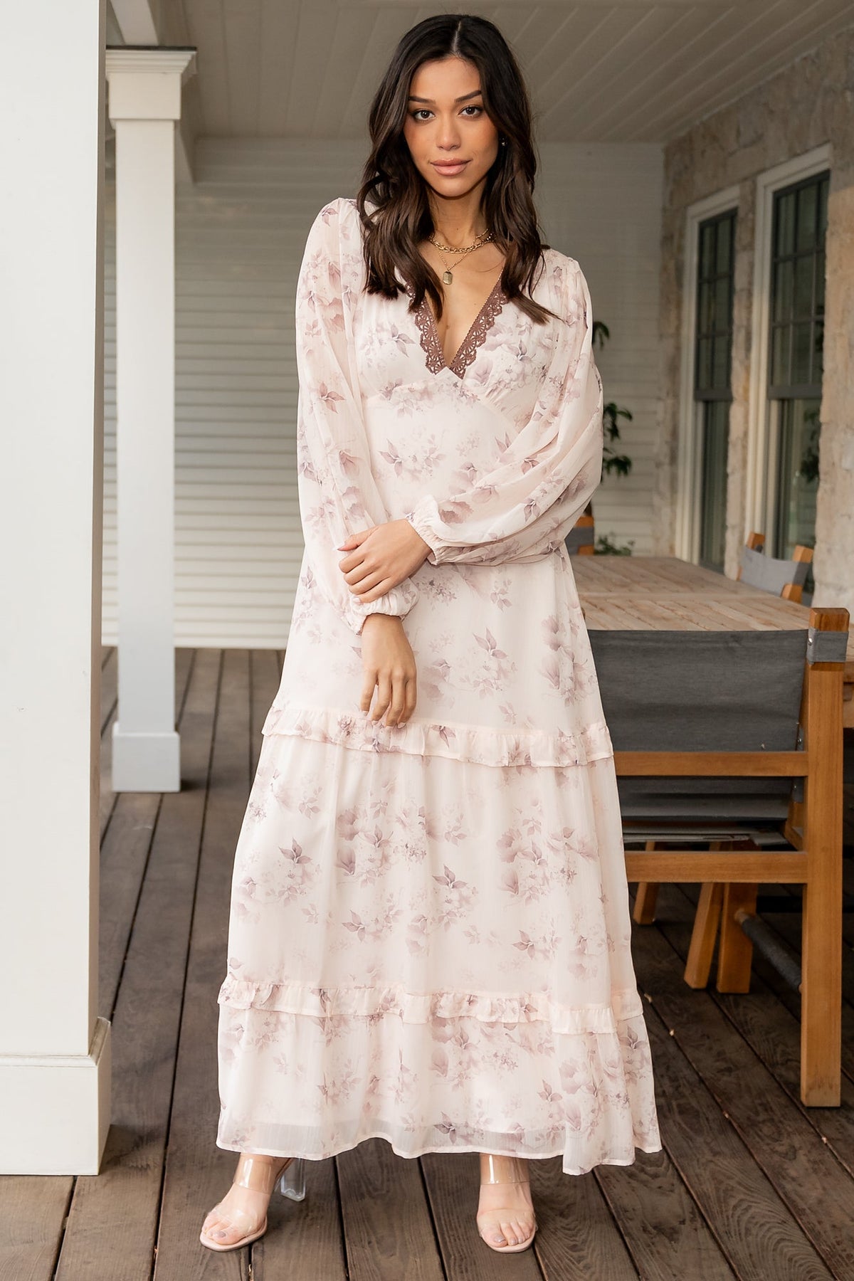 Front view of beige and clove floral chiffon maxi dress on model, showing deep V-neck, empire waist and right leg slit in soft studio light.