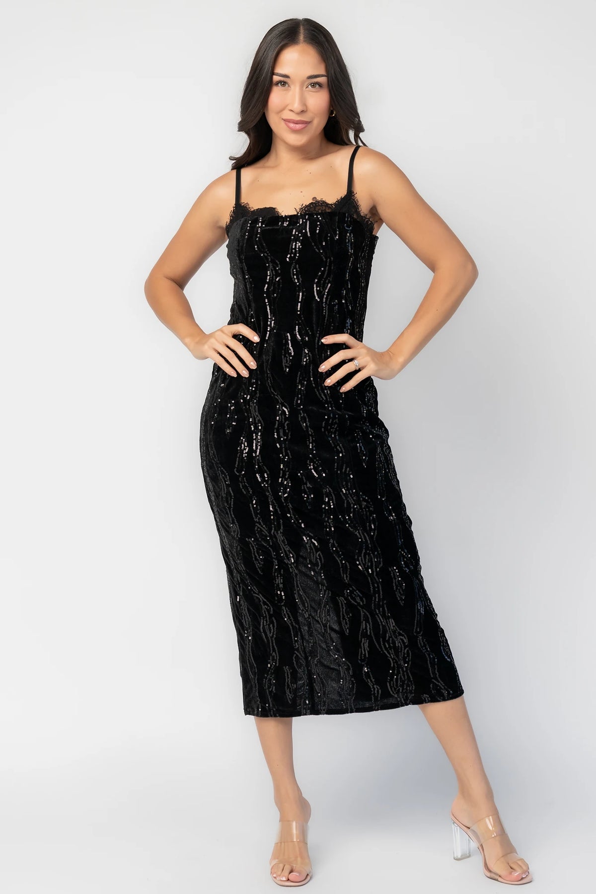 Sabina Sequin Midi Dress in Black with allover sequins, black lace neckline, spaghetti straps, and fitted silhouette.
