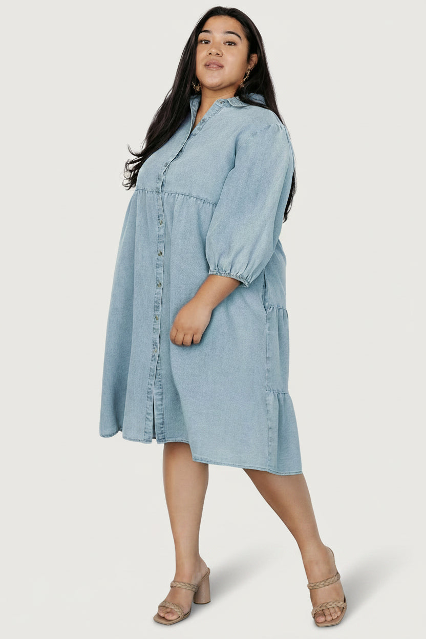 Three-quarter view of Sari Chambray Babydoll Dress showing tiers at back bodice and relaxed A-line skirt movement.