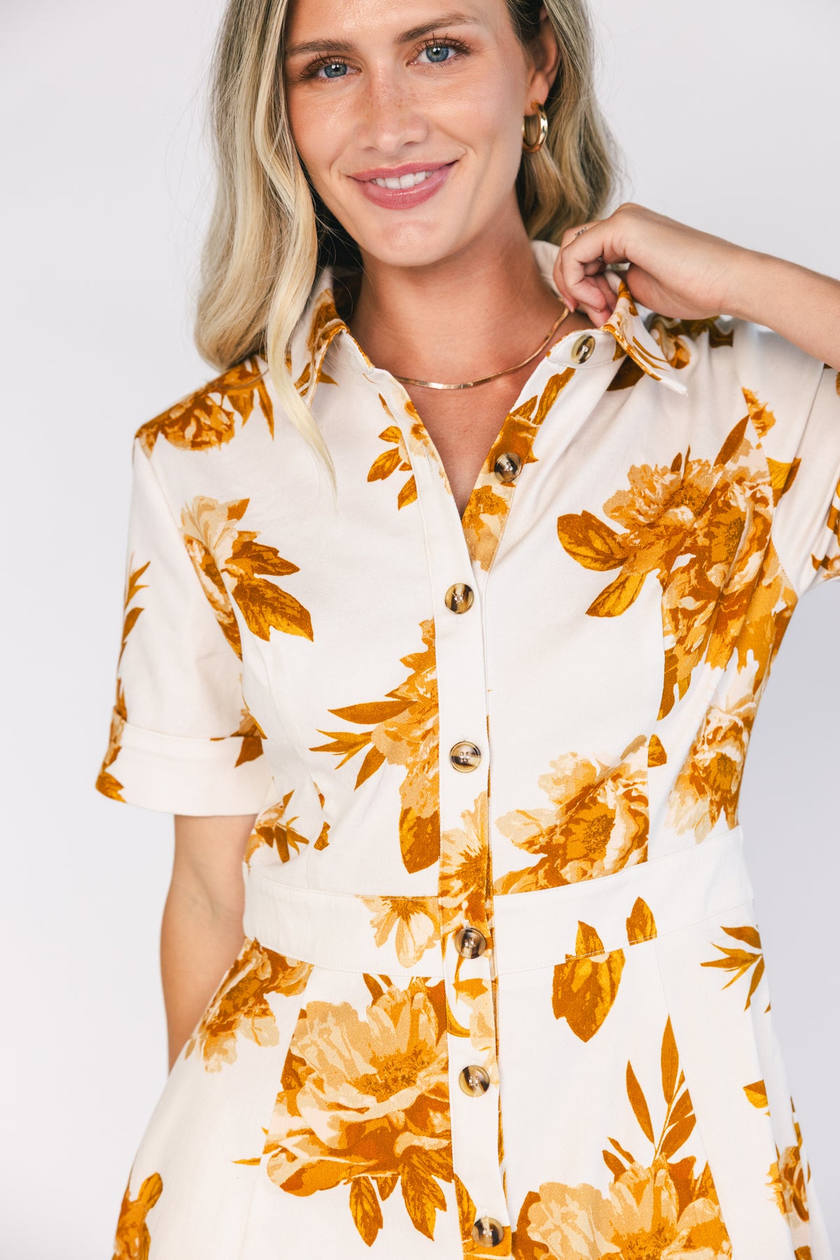 Selena Button Up Dress in Ivory + Golden Floral with collared neckline, button front, short sleeves, and fit-and-flare skirt.