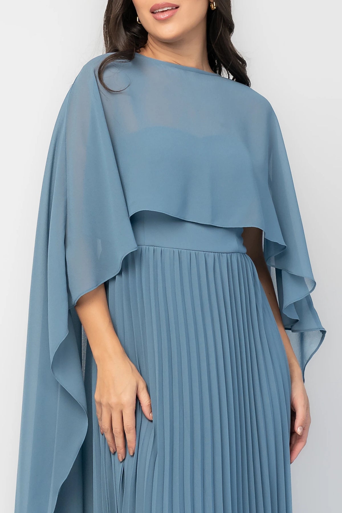 Serafina Strapless Gown in Blue with strapless neckline, removable sheer cape overlay, defined waist, and pleated skirt.