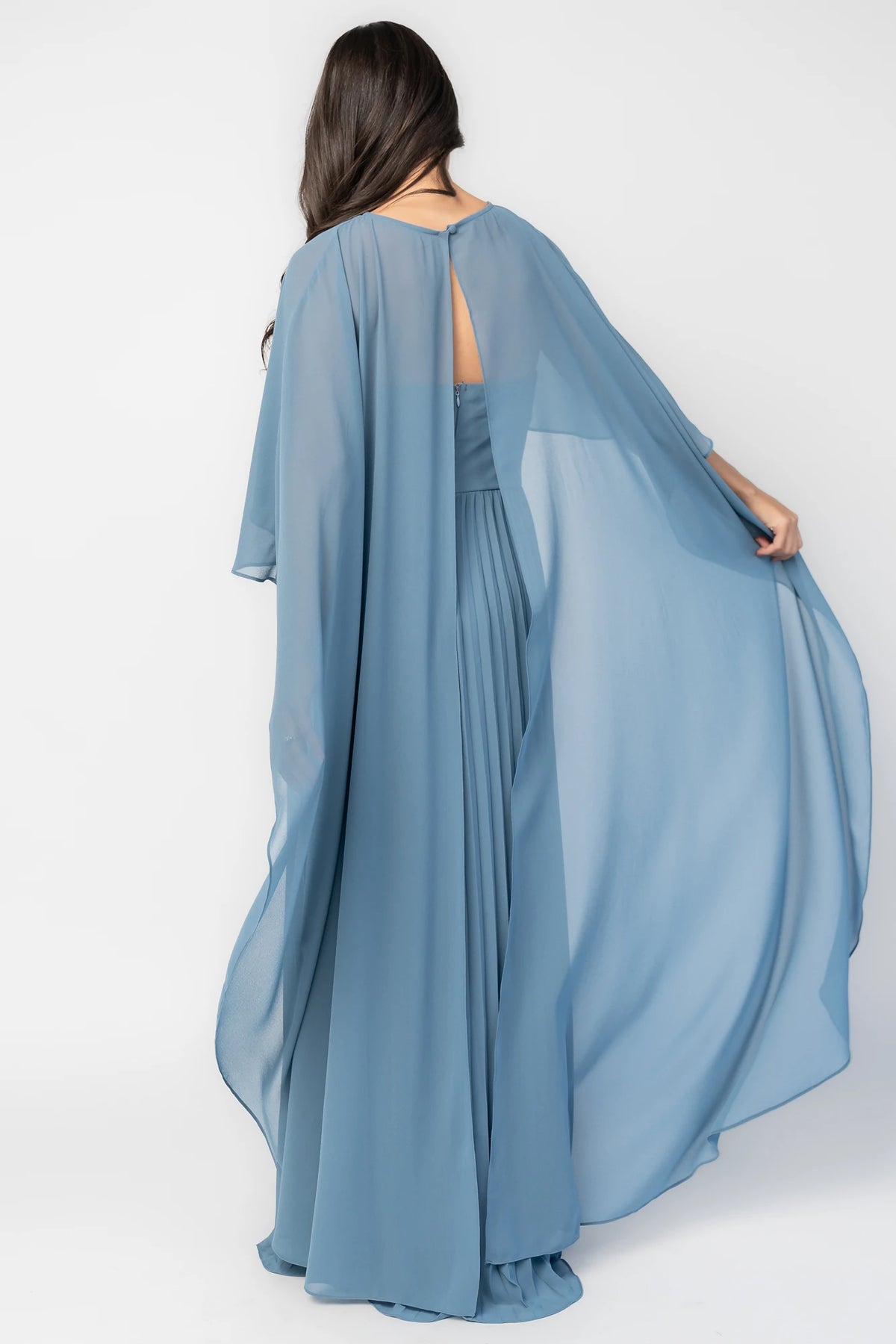 Serafina Strapless Gown in Blue with strapless neckline, removable sheer cape overlay, defined waist, and pleated skirt.