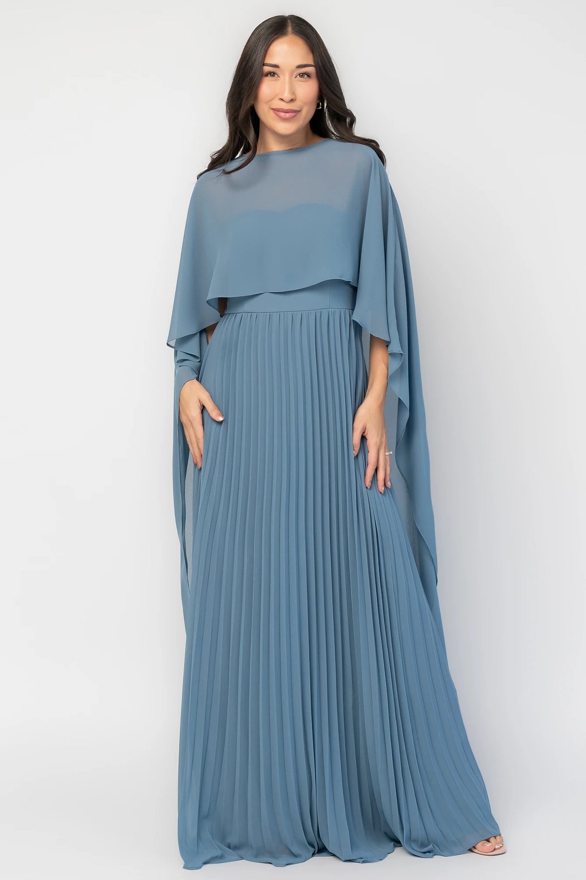 Serafina Strapless Gown in Blue with strapless neckline, removable sheer cape overlay, defined waist, and pleated skirt.