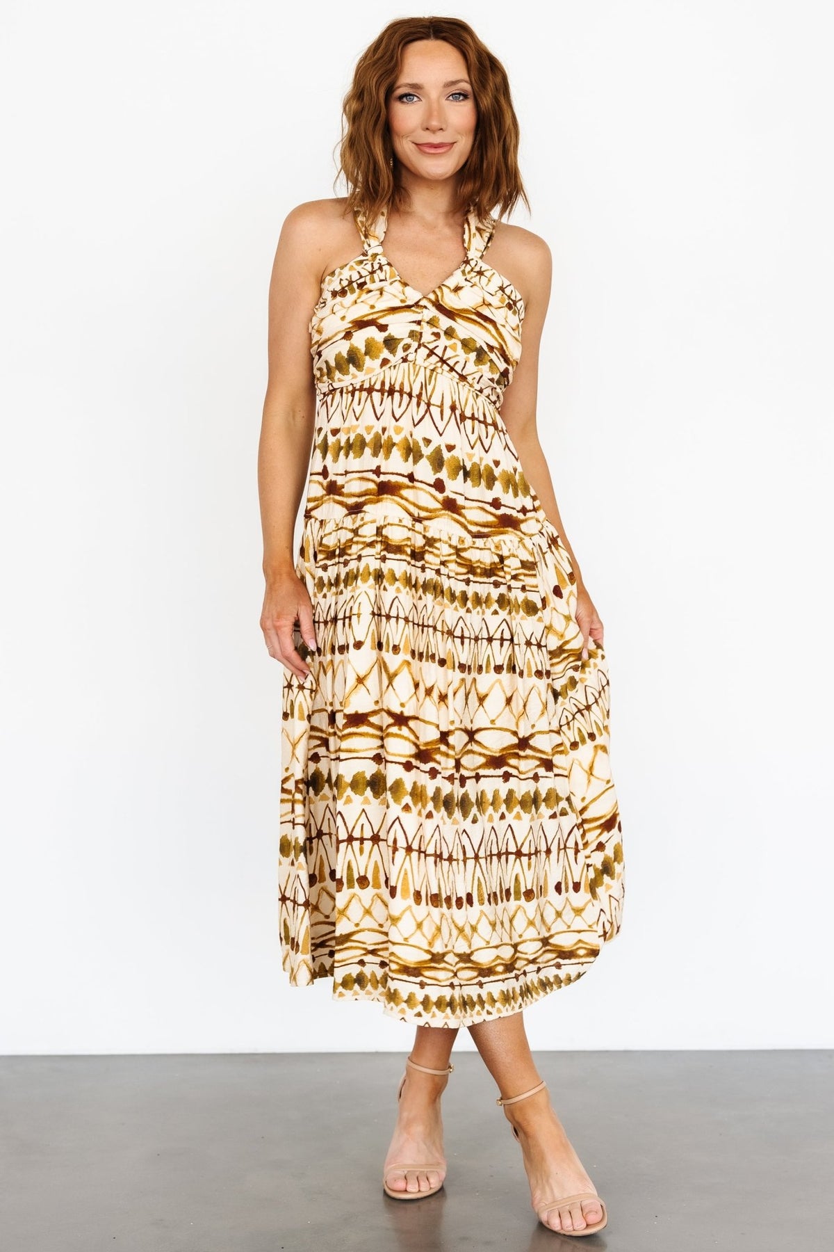Side view of the Seraphina midi dress in tan multi showing hidden left-side zipper and single-tier skirt silhouette.