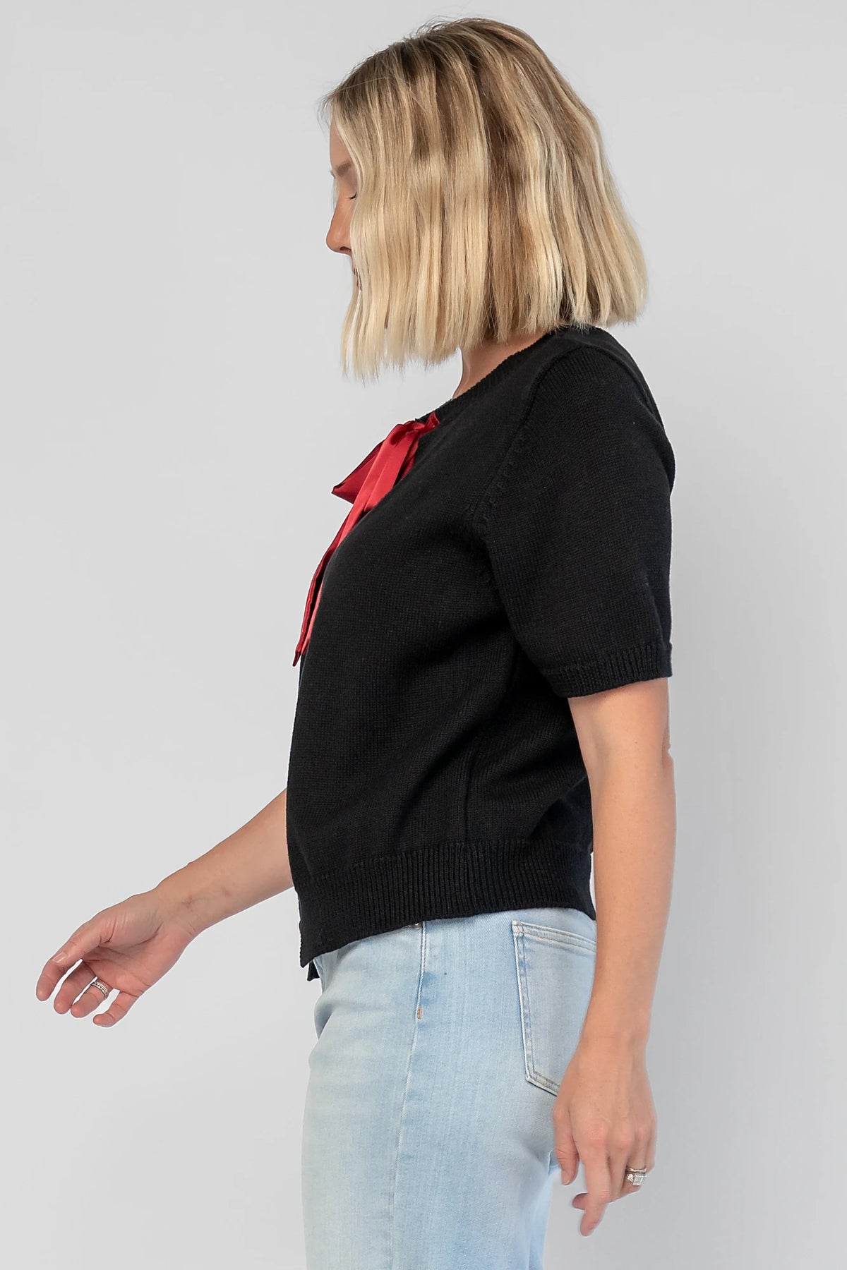 Shaye Sweater Top in Black with a built-in tank, satin bow tie closure, and soft knit construction.