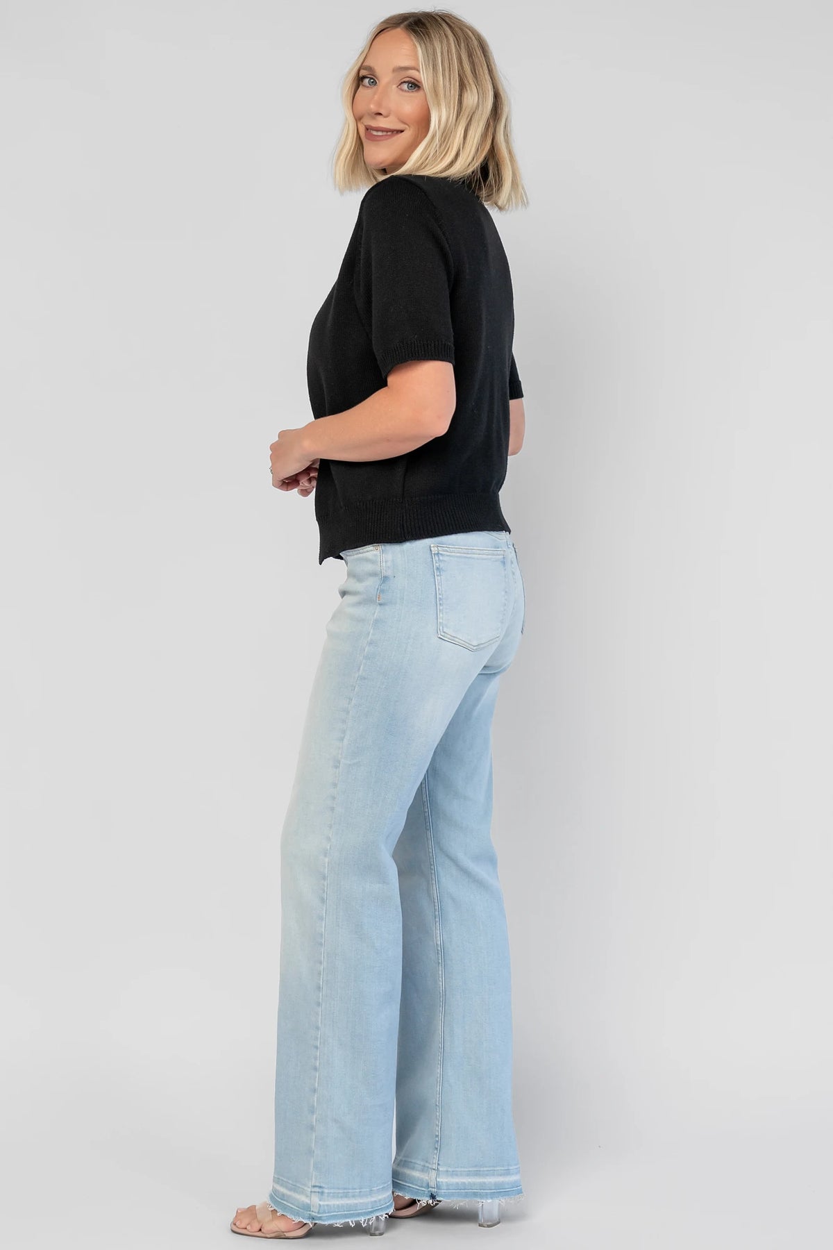Shaye Sweater Top in Black with a built-in tank, satin bow tie closure, and soft knit construction.