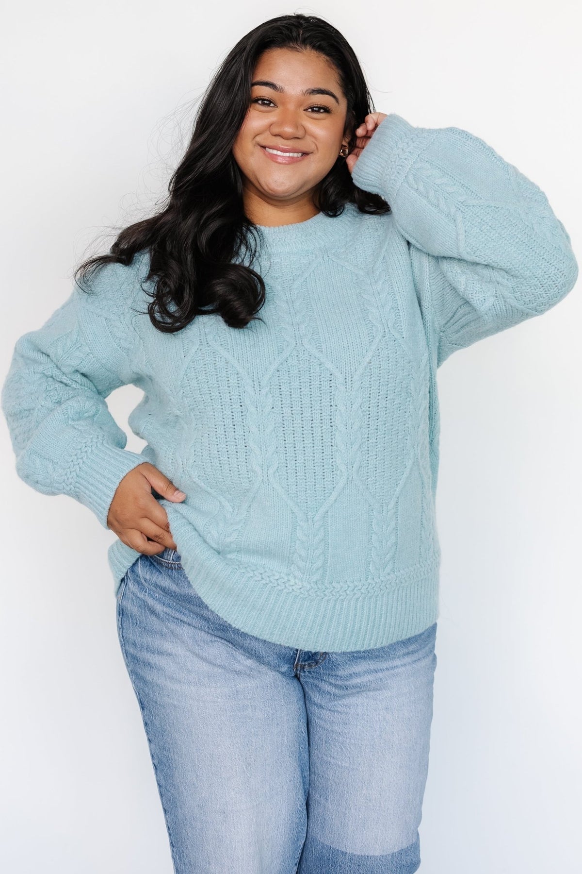Detail shot of sleeve cuff and cable knit pattern on the Sheffield sweater in vintage light blue, highlighting stitch texture.