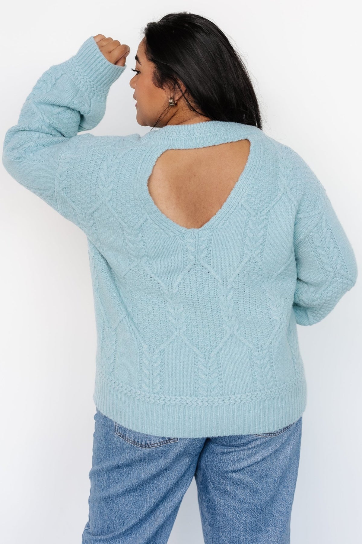 Sheffield cable-knit sweater in light blue folded to display knit texture and vintage color for product merchandising.