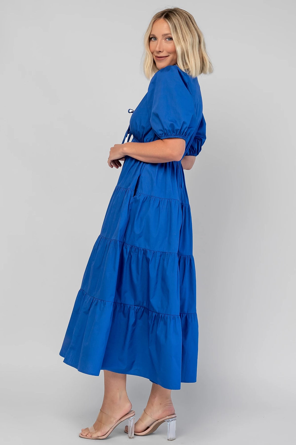 Sheila Tiered Midi Dress in Cobalt with V-neckline, front ties, puff sleeves, smocked empire waist, and tiered skirt.