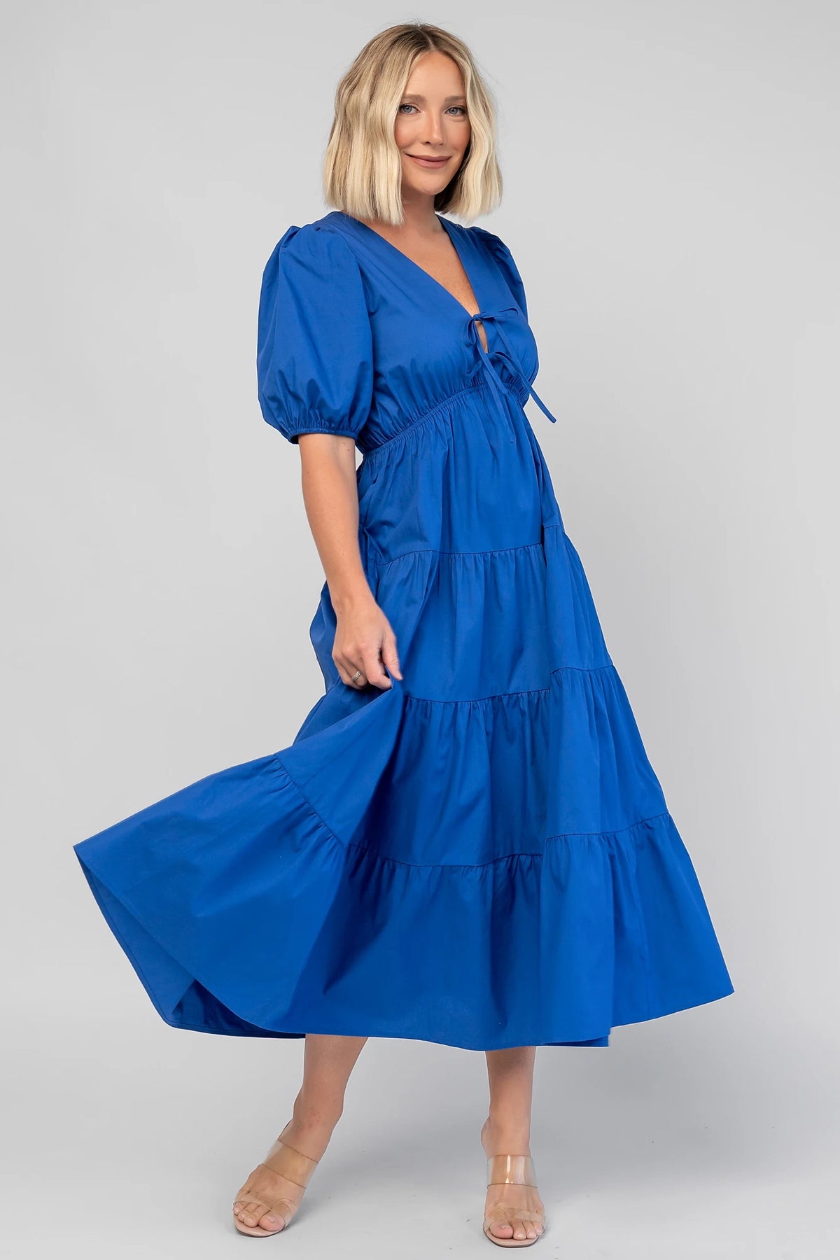 Sheila Tiered Midi Dress in Cobalt with V-neckline, front ties, puff sleeves, smocked empire waist, and tiered skirt.