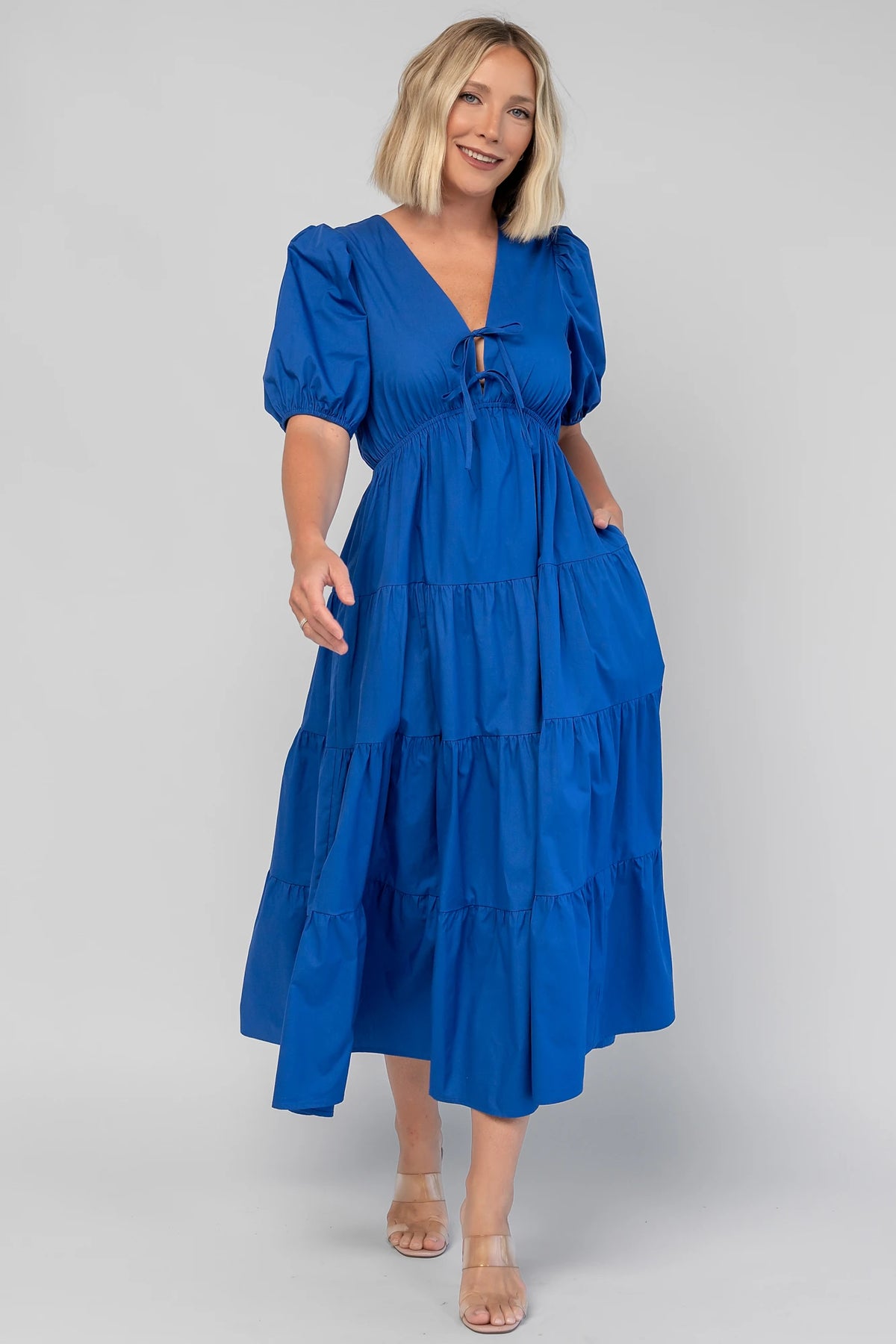 Sheila Tiered Midi Dress in Cobalt with V-neckline, front ties, puff sleeves, smocked empire waist, and tiered skirt.