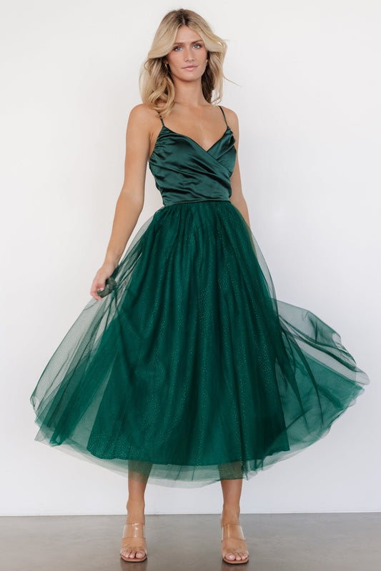 Front view of emerald Shonda Sparkle midi dress showing crossed satin-like V-neck bodice, adjustable straps, and sparkling layered tulle skirt.