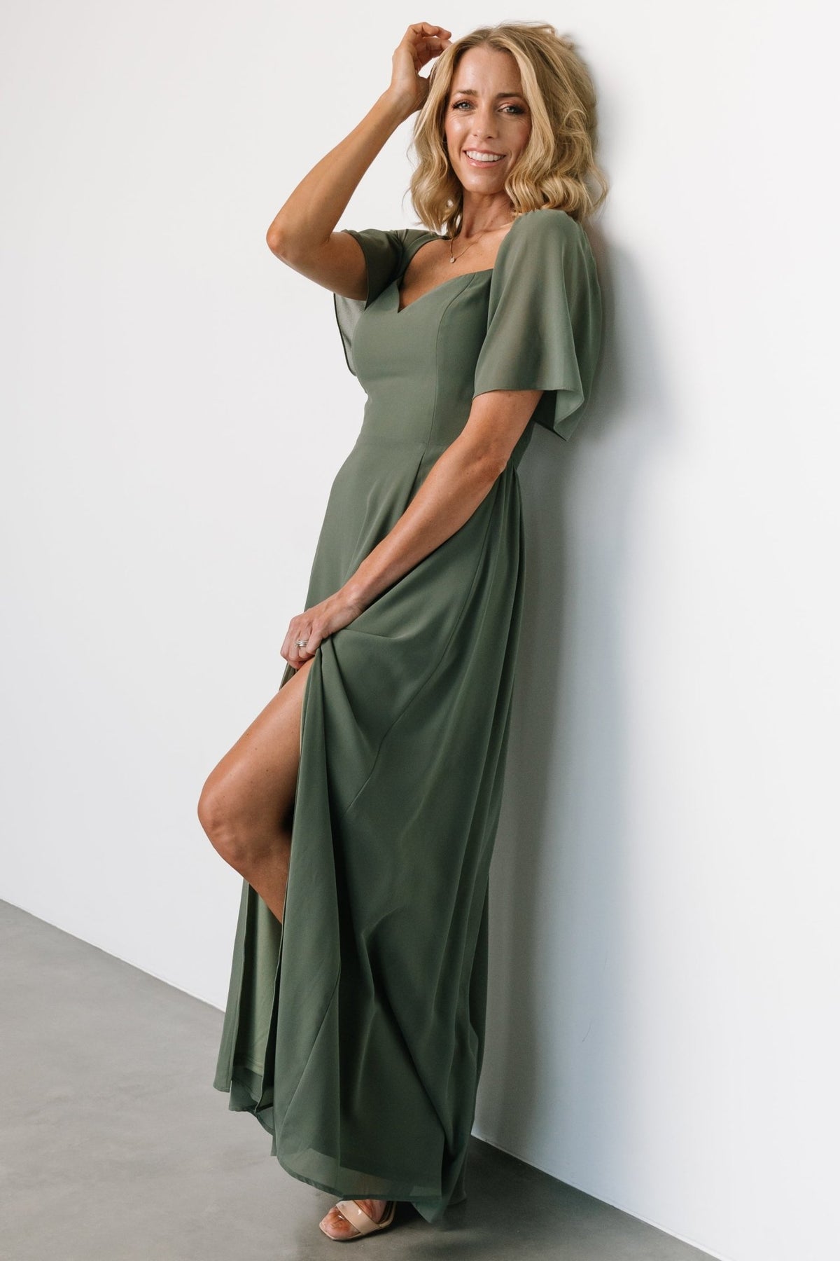Styled look of Sierra Sweetheart Maxi Dress in dark sage with accessories, showing overall fit and elegant maxi length.