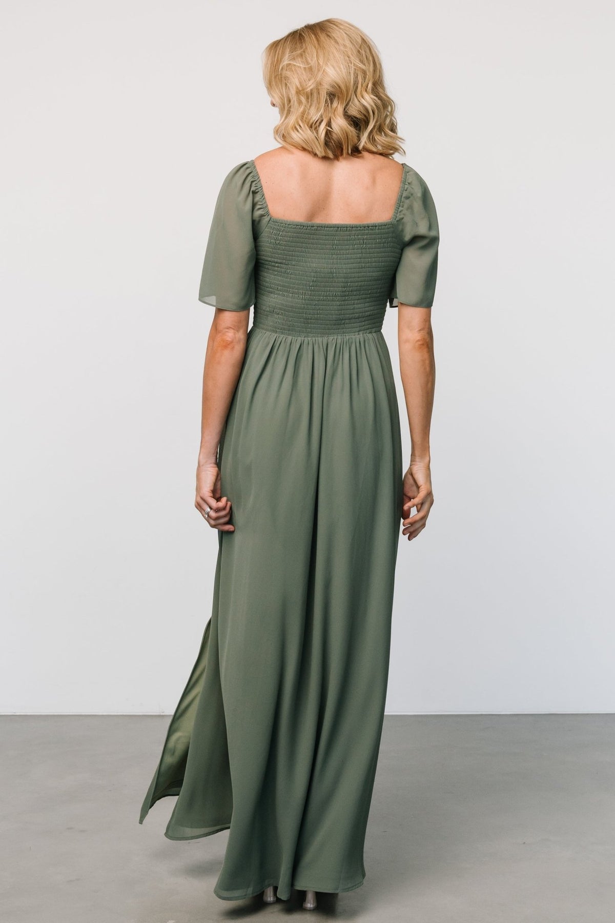 Detail of sheer flutter sleeve and elastic shoulder on the Sierra Sweetheart Maxi Dress in dark sage, showing fabric texture.