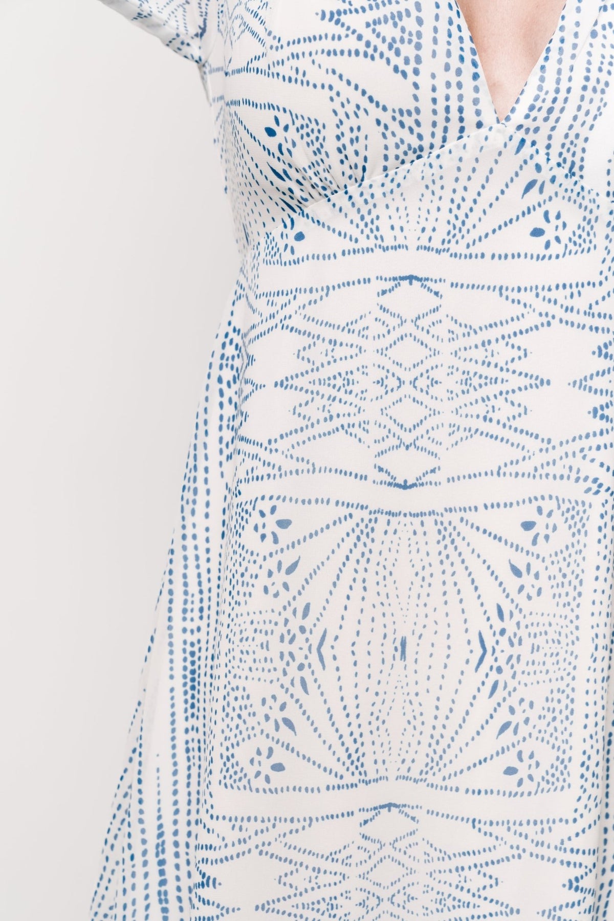 Full-length image of Skyla Deep V Maxi Dress highlighting flowing chiffon maxi skirt and overall blue abstract print on off-white base.