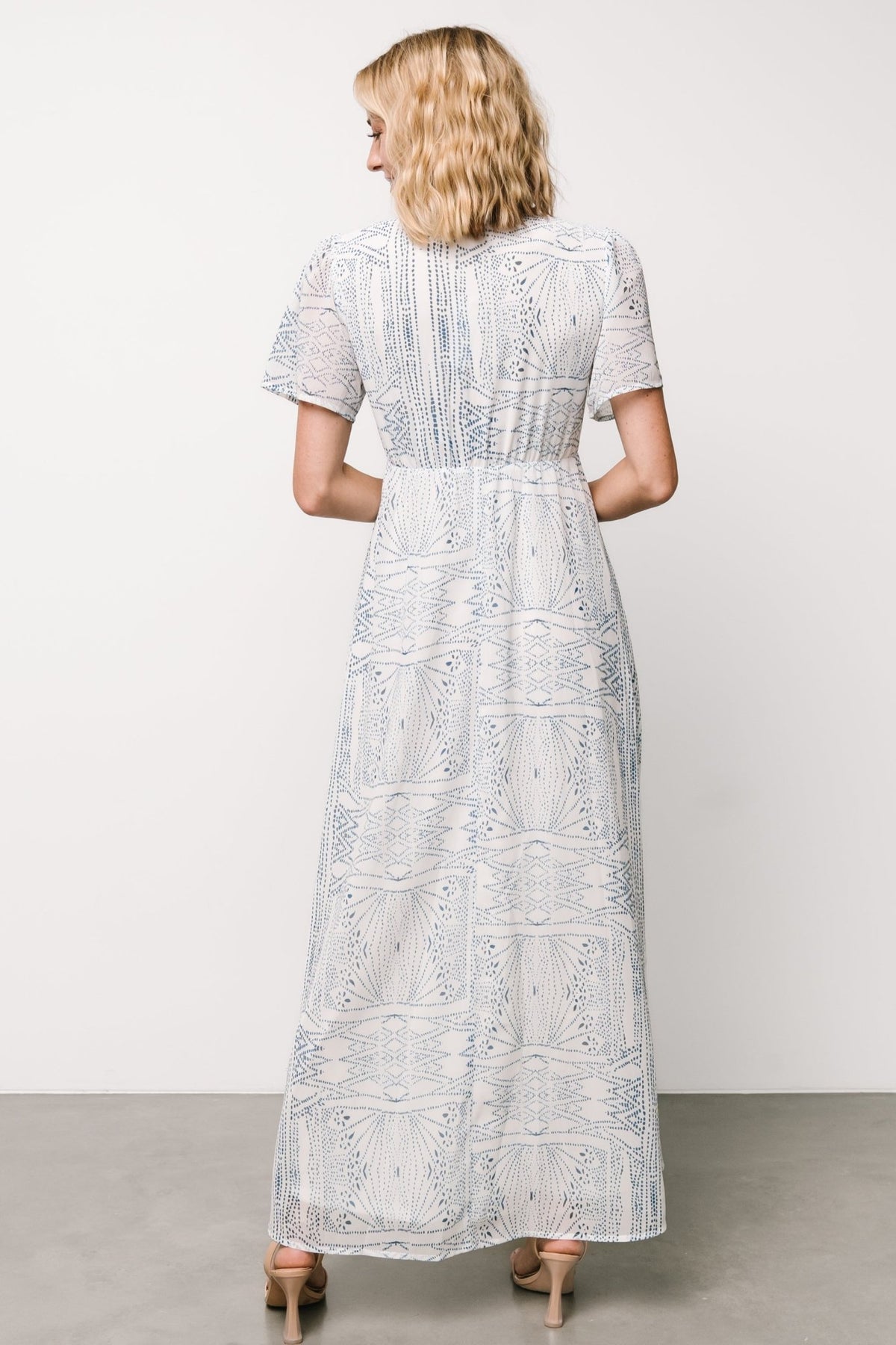 Detail shot of Skyla Deep V Maxi Dress fabric and print with emphasis on chiffon texture, lining edge, and subtle gathered waist.