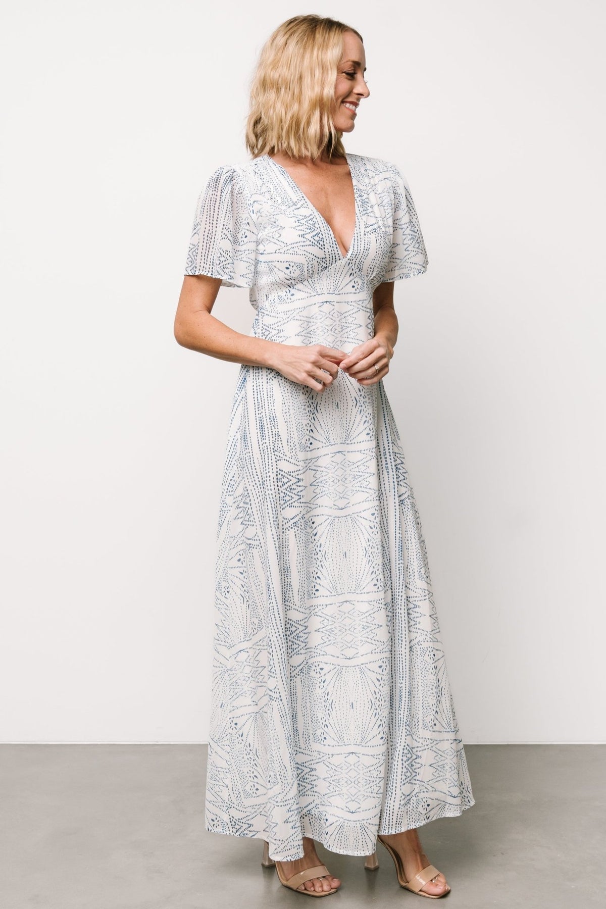 Back view of Skyla dress showing elasticated back waist and skirt drape; chiffon fabric and print visible in natural light.