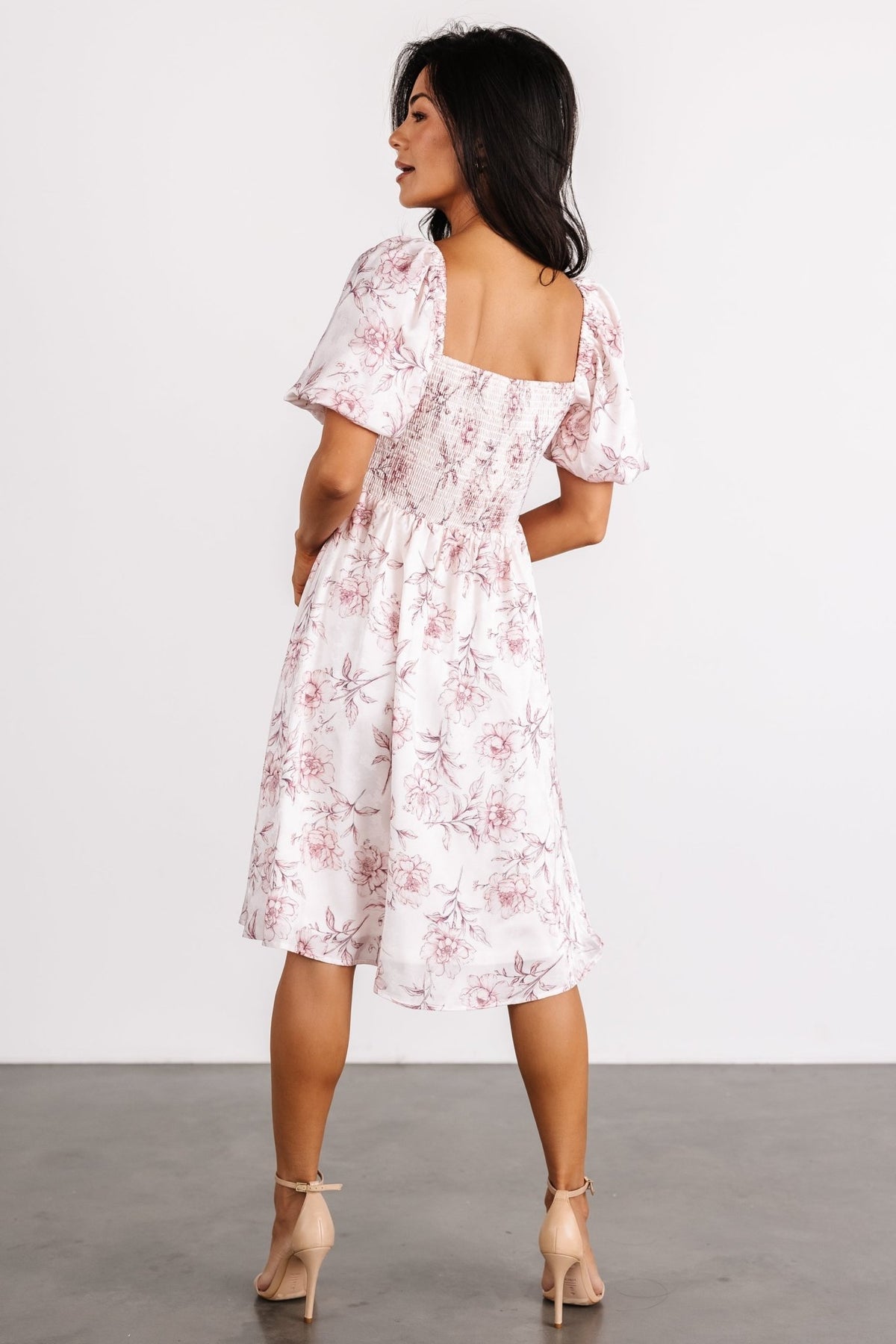 Side view of Sonnet Short Dress displaying short puff sleeve with elastic cuff and the dress's gentle A-line silhouette on model.