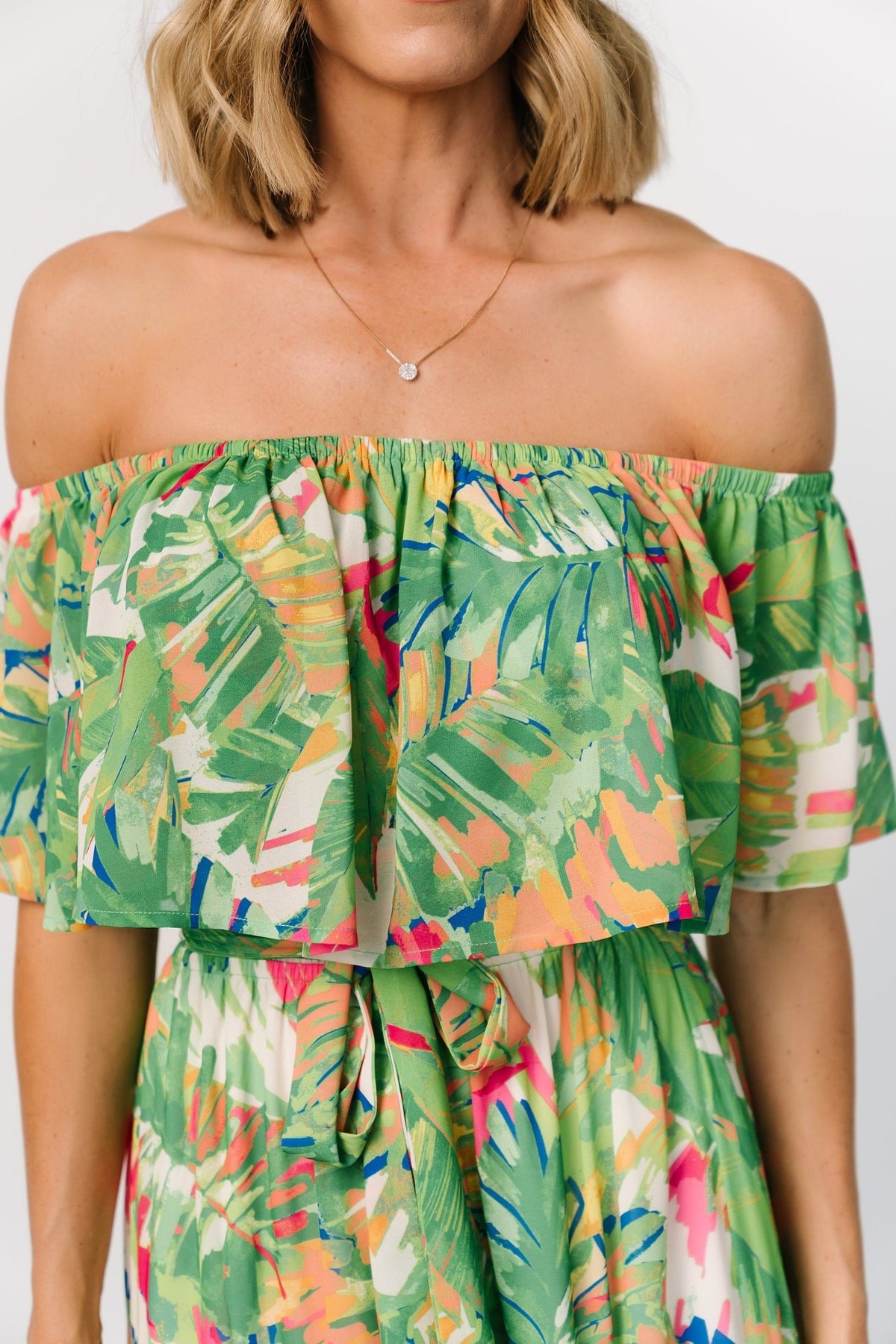 Back view of Sonoma maxi dress showing elastic off-shoulder detail, full lined tiered skirt, and vibrant green multi tropical pattern.