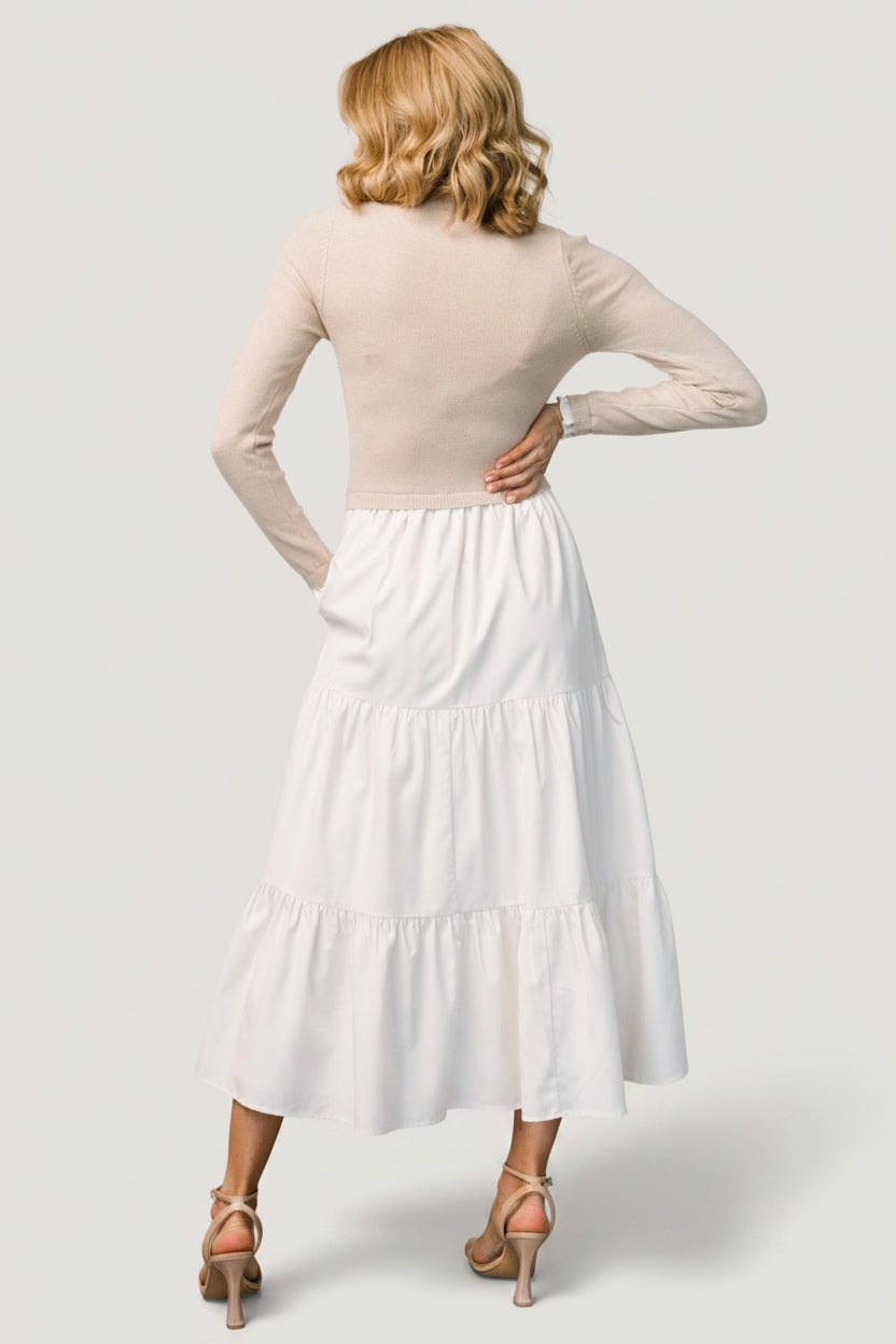 Back view of Sophie Sweater Dress in Natural showing seam lines and tiered skirt construction.