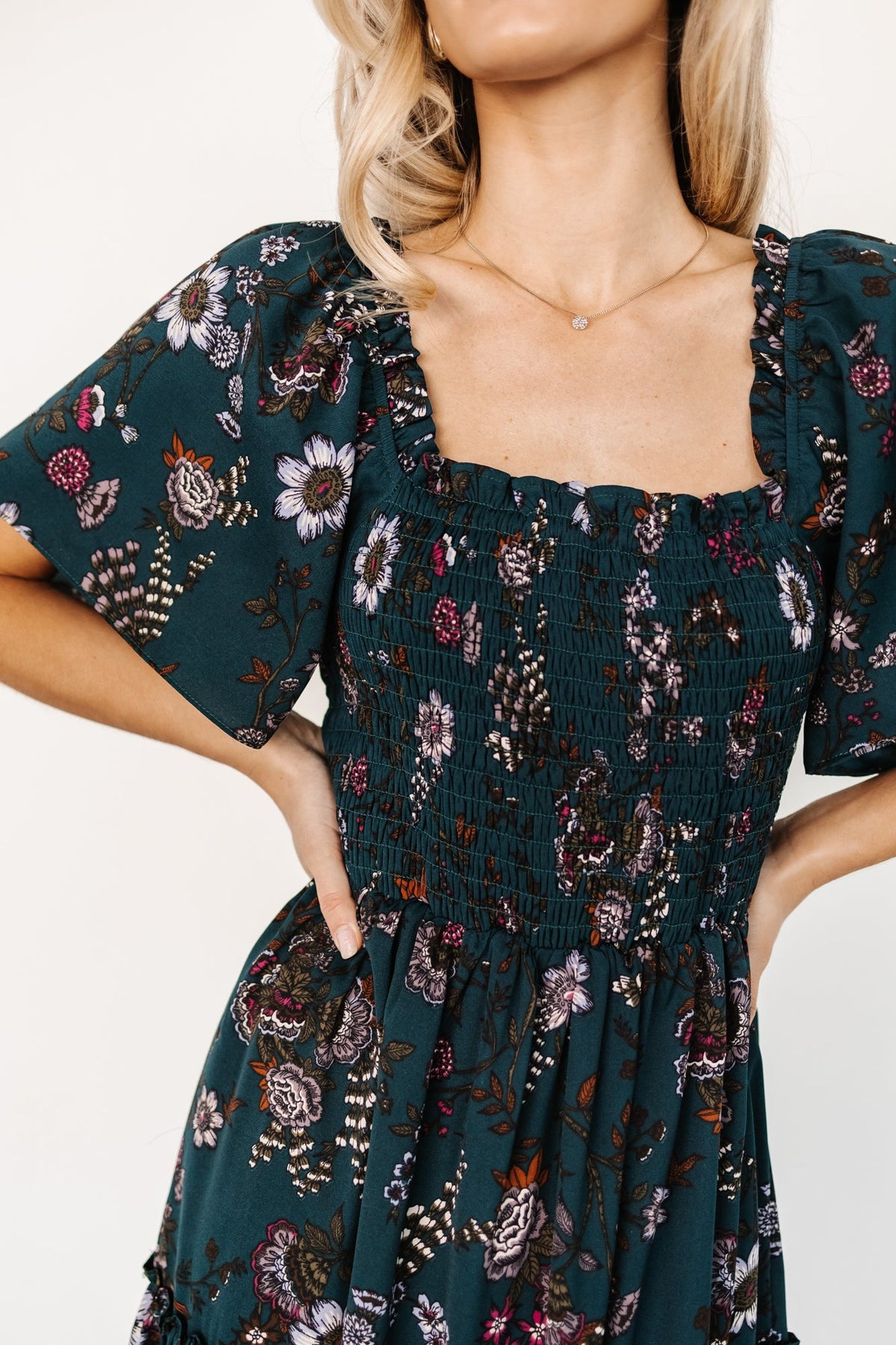 Styled look of Southampton smocked maxi dress in jade blossom on model standing outdoors, highlighting overall silhouette and pattern.