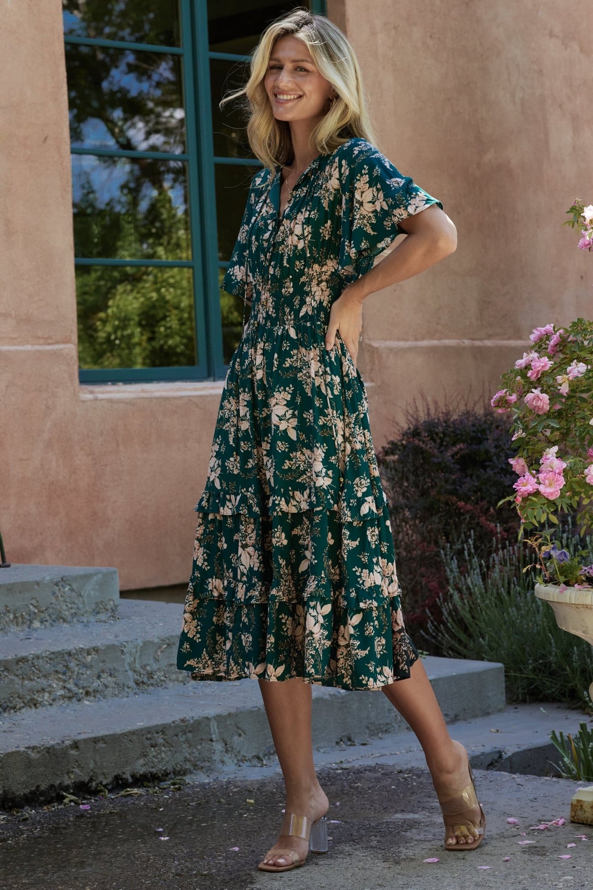 Side view of smocked waist and flowing skirt of the Spell Boho Midi Dress in topaz and blush, highlighting drape and midi length.