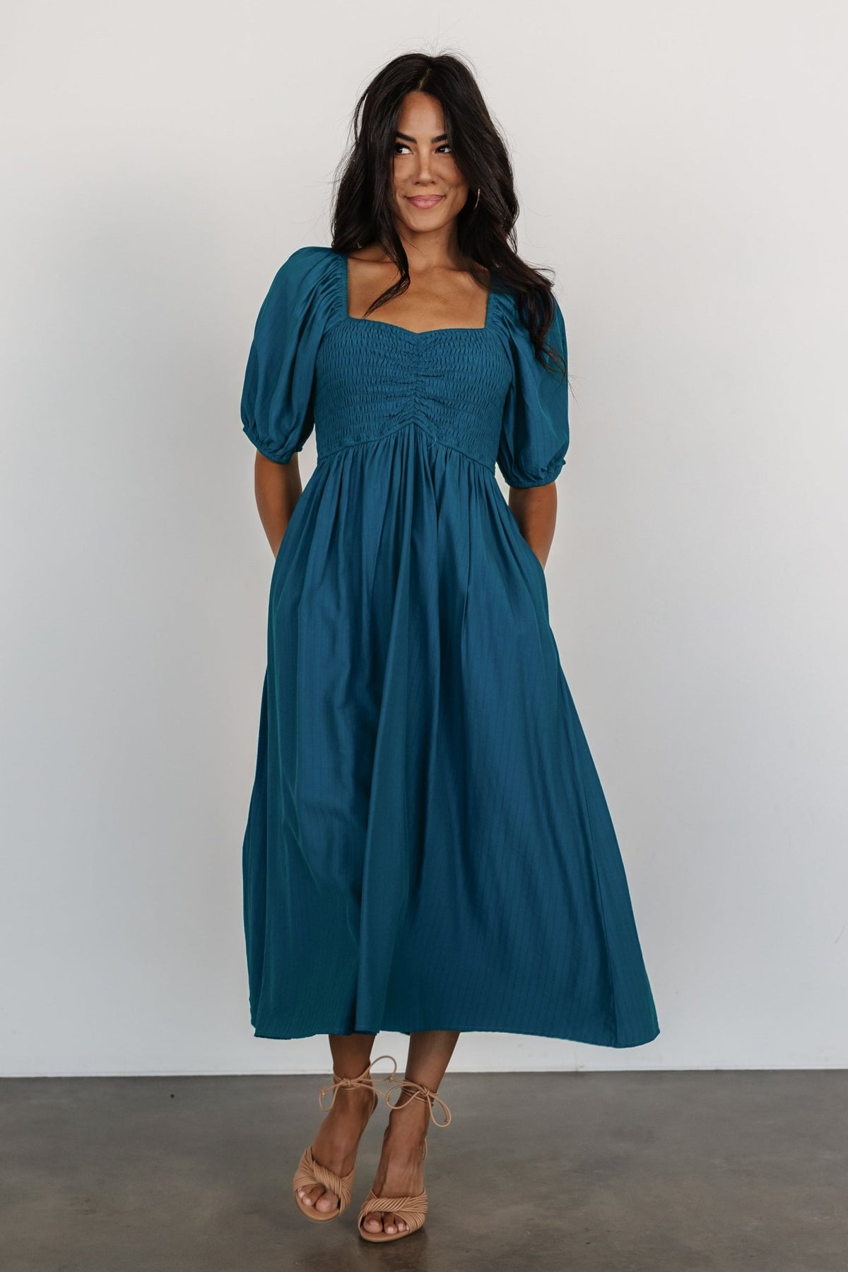 Back view of Stefania Midi Dress in Mediterranean Blue displaying the gathered smocked back, airy chiffon drape, and mid-calf A-line fall for movement.