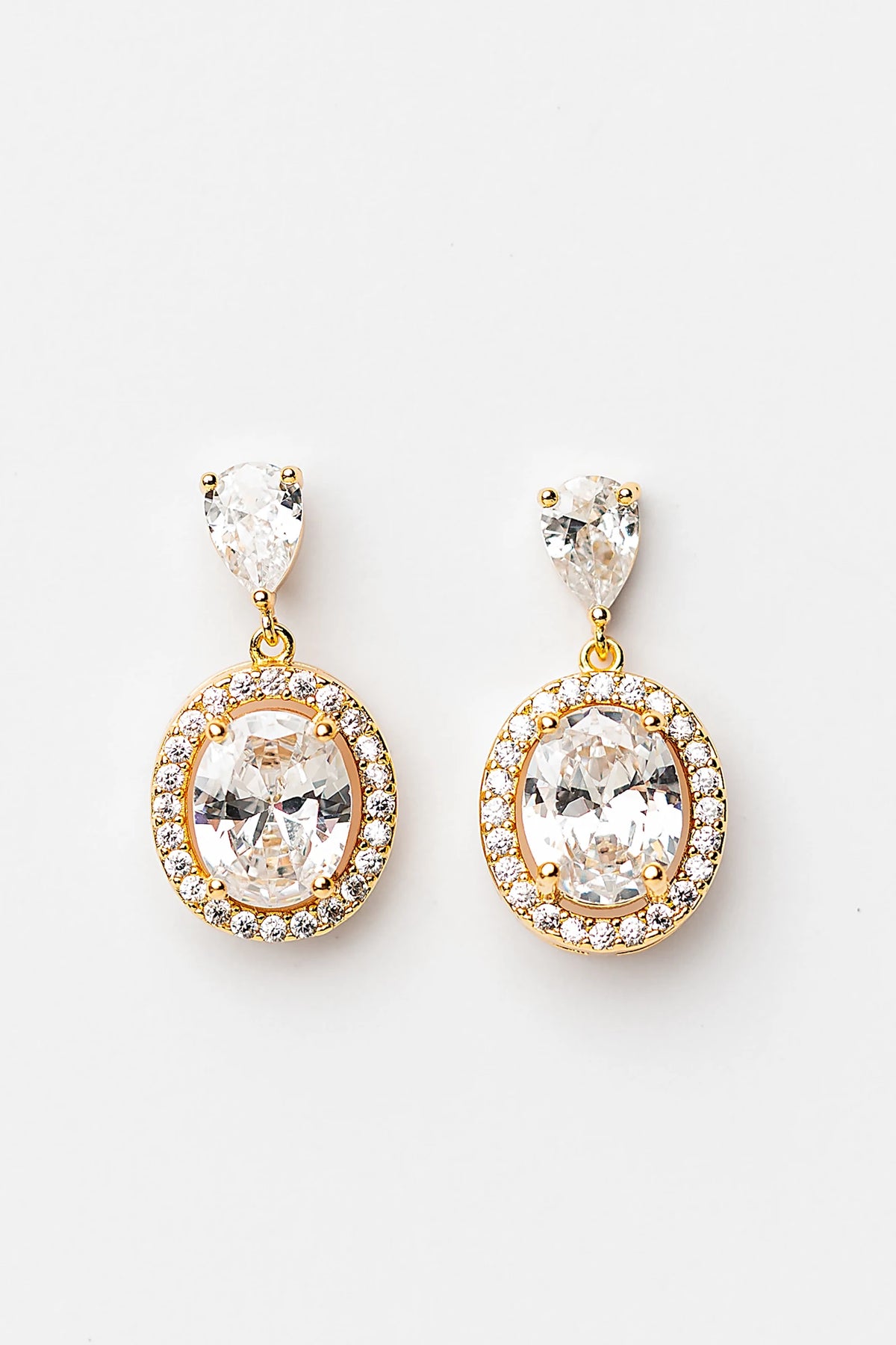 Stena Oval Dangle Drop Earrings in Gold with oval center stone and pavé stone border.
