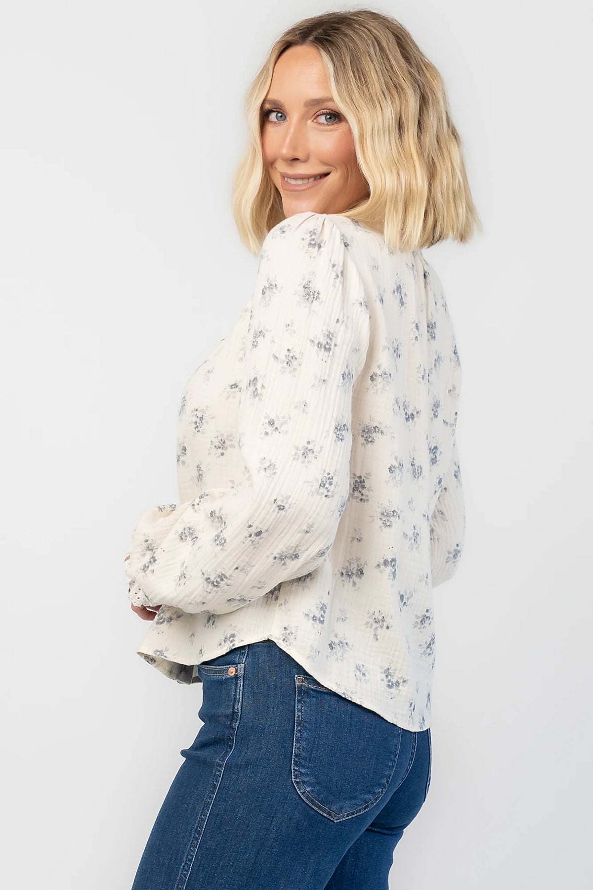 Stephanie Button Front Blouse in Ivory + Blue Floral with a lace-trimmed tie neckline and a button-front design.