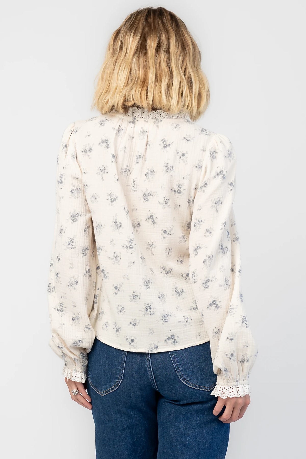Stephanie Button Front Blouse in Ivory + Blue Floral with a lace-trimmed tie neckline and a button-front design.