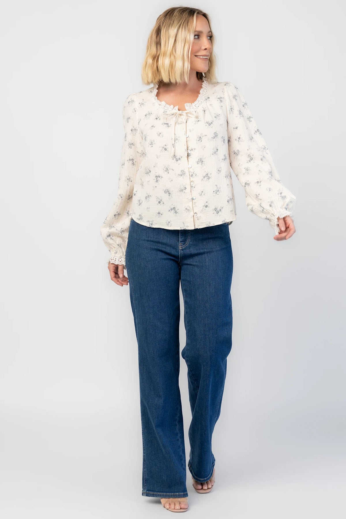 Stephanie Button Front Blouse in Ivory + Blue Floral with a lace-trimmed tie neckline and a button-front design.
